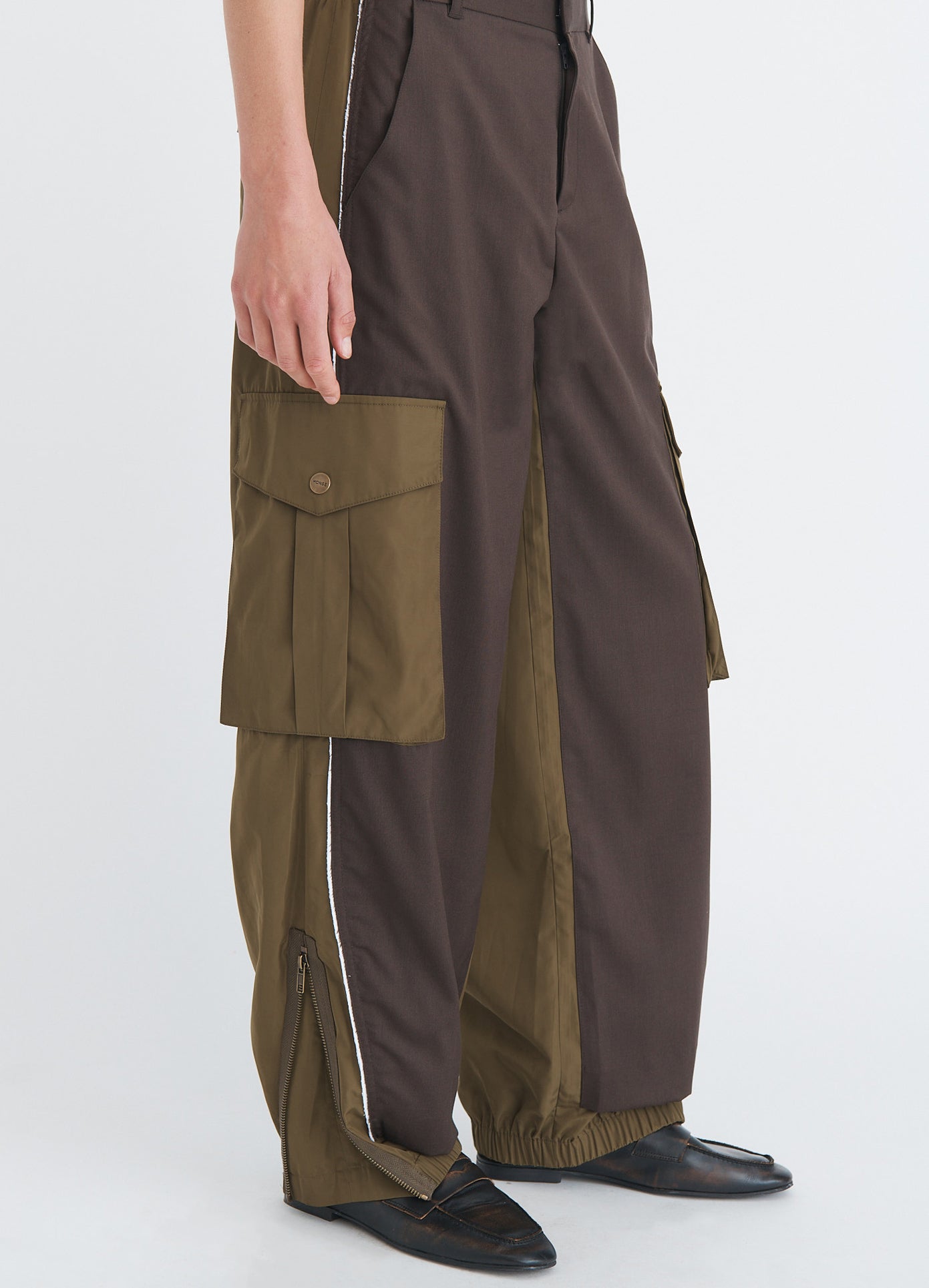 MONSE Deconstructed Combo Pants in olive and dark grey on model side detail view