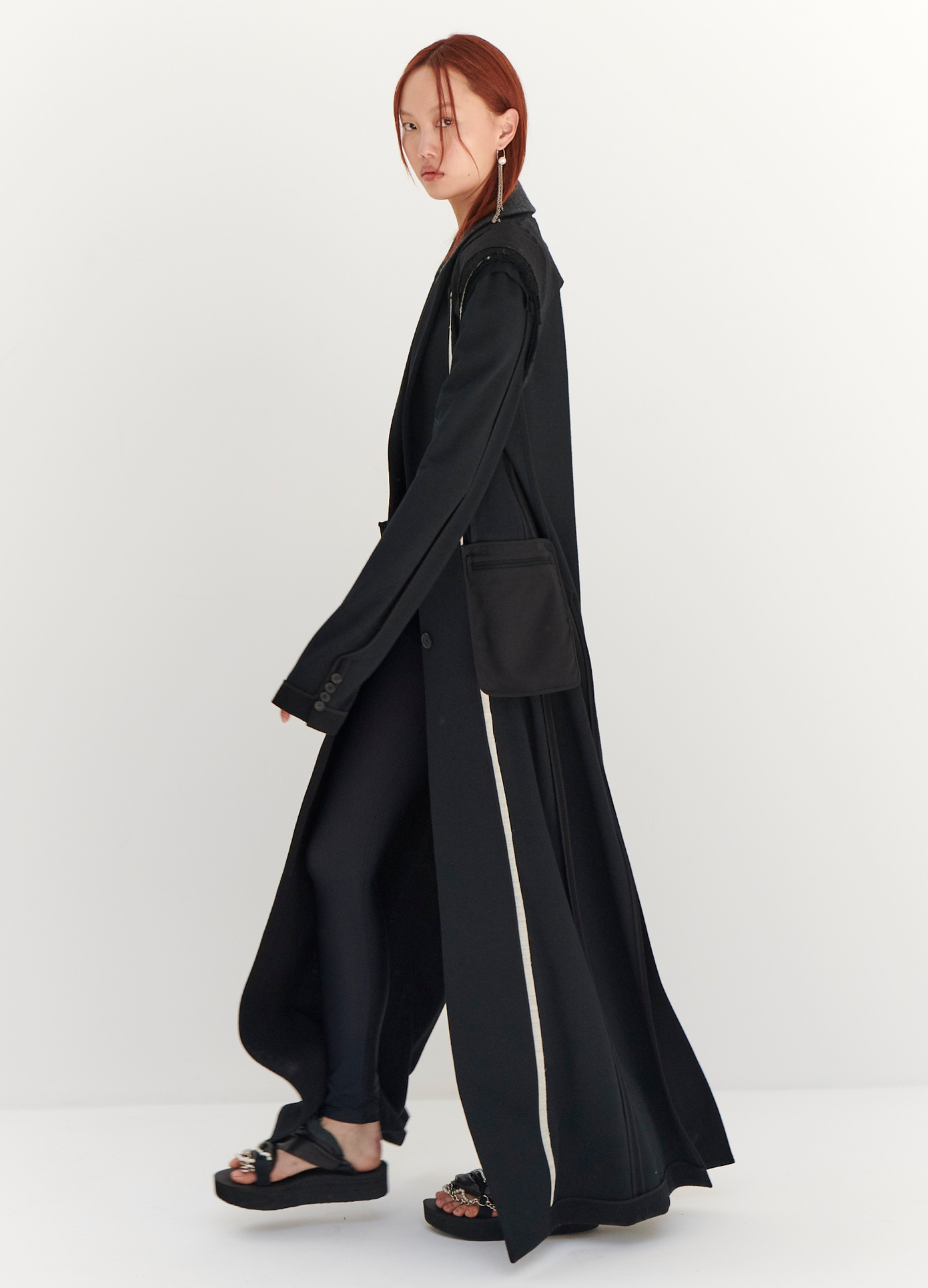 MONSE Floor Length Reversed Coat in Black on model walking full side view