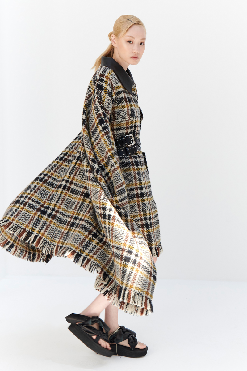 MONSE Resort 2024 Collection Vogue image of model wearing a checkered jacket side view