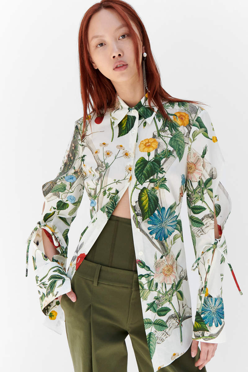 MONSE Resort 2024 Collection Vogue image of model wearing a floral button down shirt with green trousers