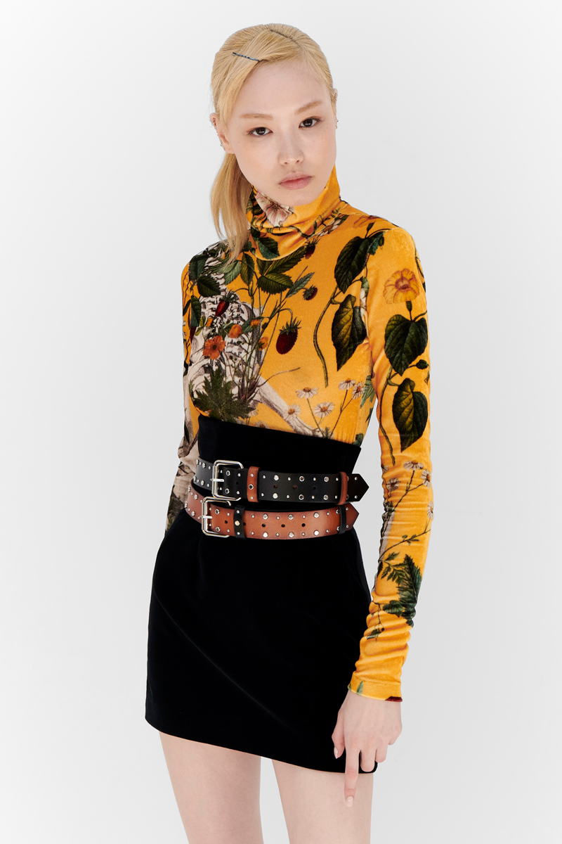 MONSE Resort 2024 Collection Vogue image of model wearing a yellow floral print turtleneck with a black skirt