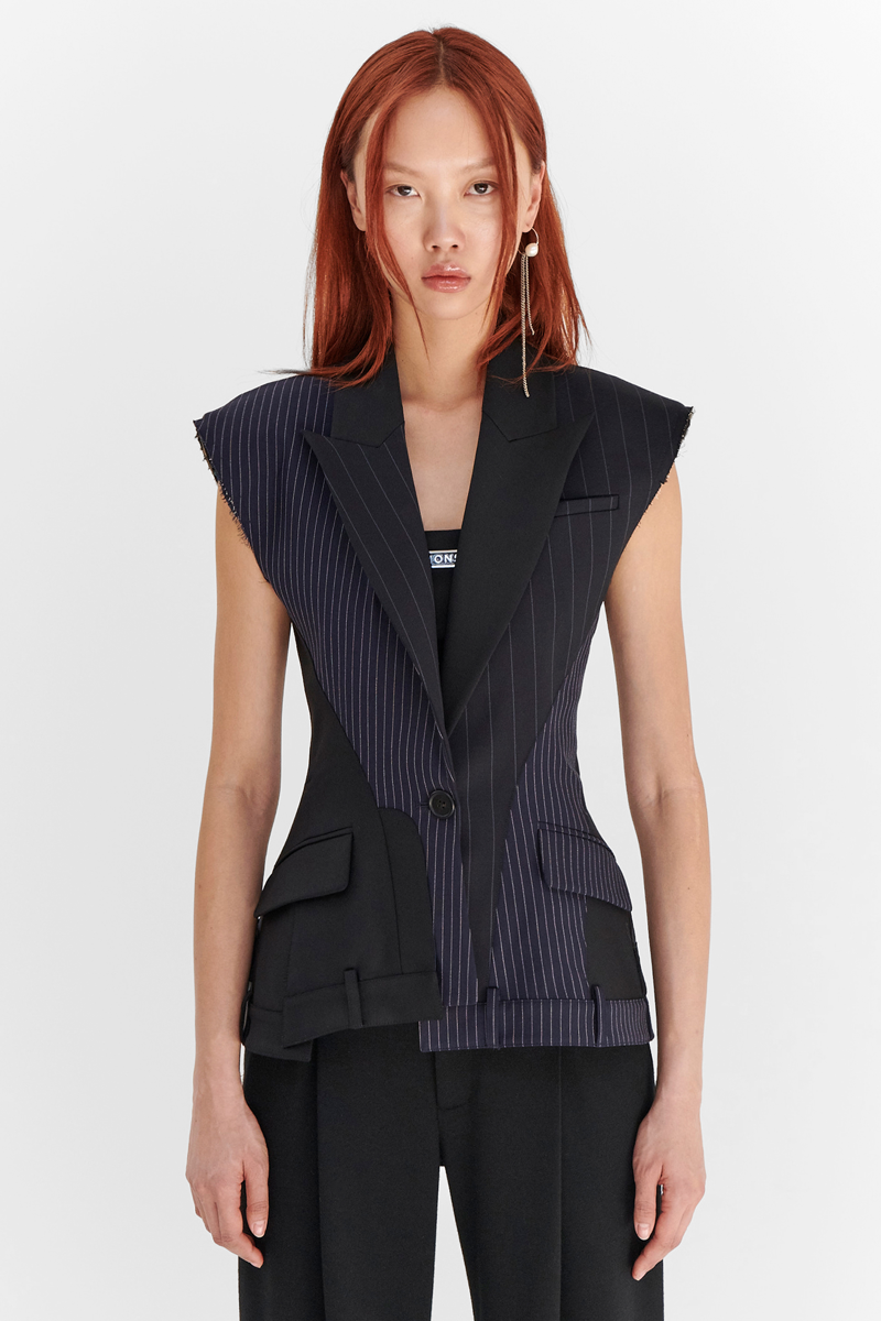 MONSE Resort 2024 Collection Vogue image of model wearing a sleeveless suit jacket with black trousers