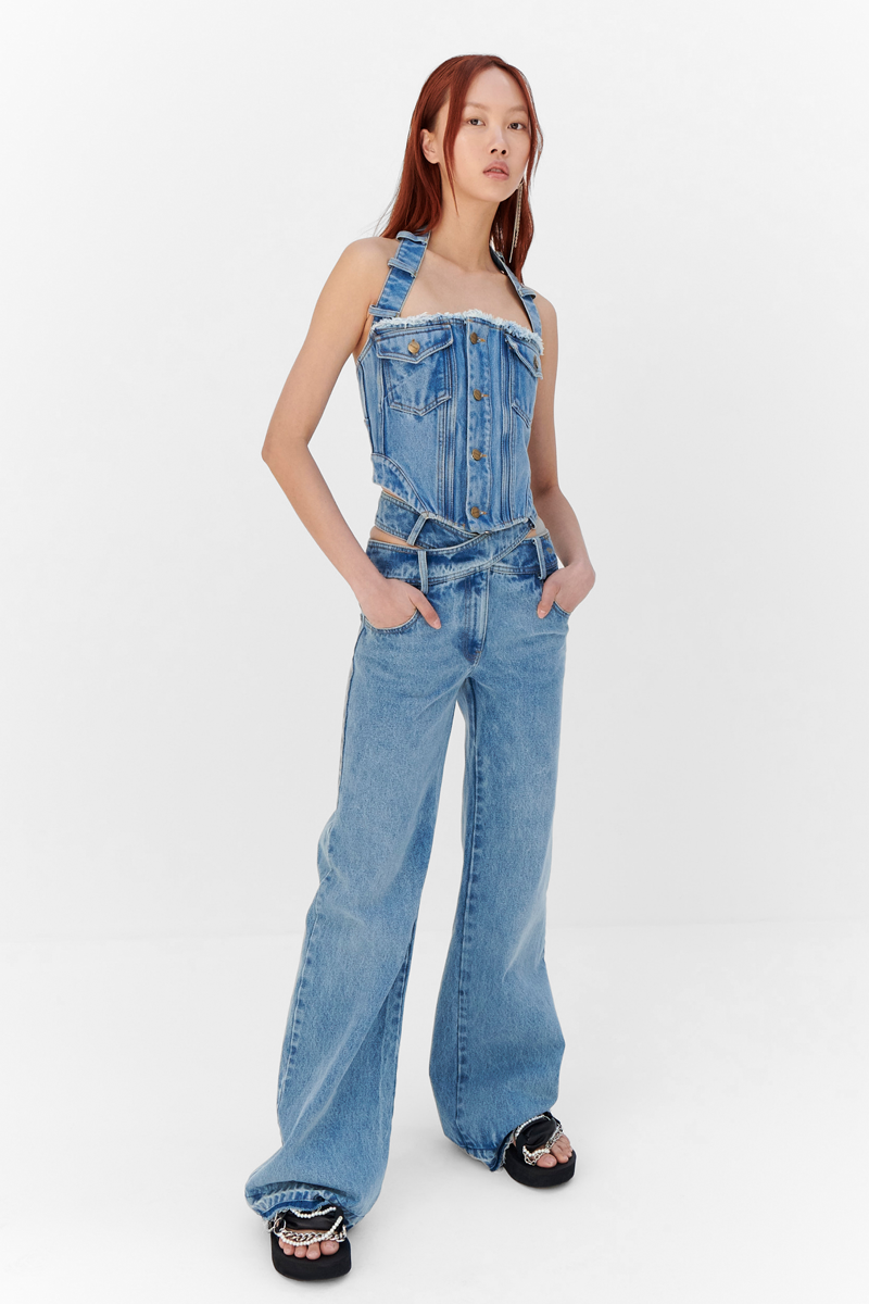 MONSE Resort 2024 Collection Vogue image of model wearing a jean halter top with jeans