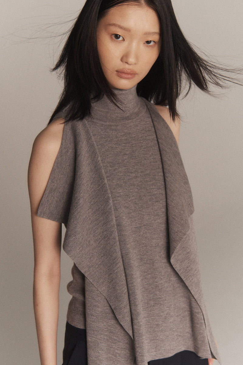 MONSE Resort 2026 collection lookbook image of a model wearing a brown sleeveless top with a draped design against a neutral background