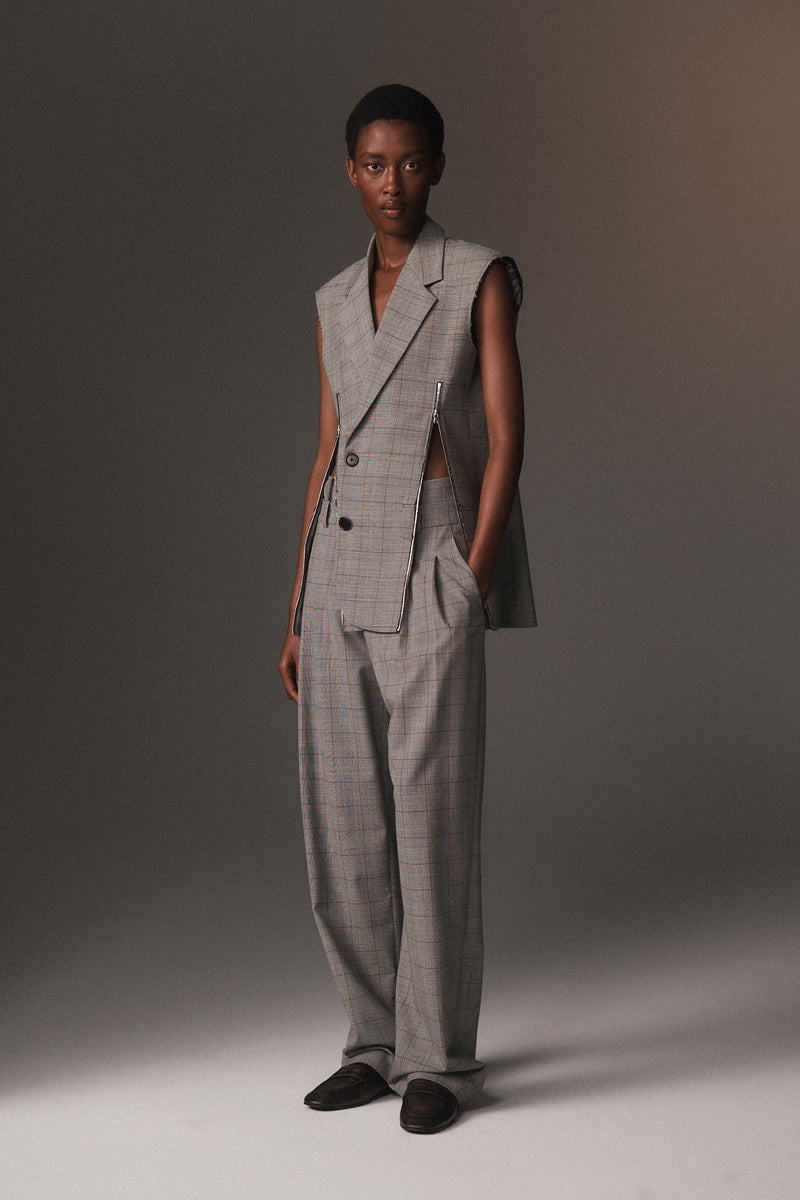 MONSE Resort 2026 collection lookbook image of a model wearing a gray checkered suit against a neutral background