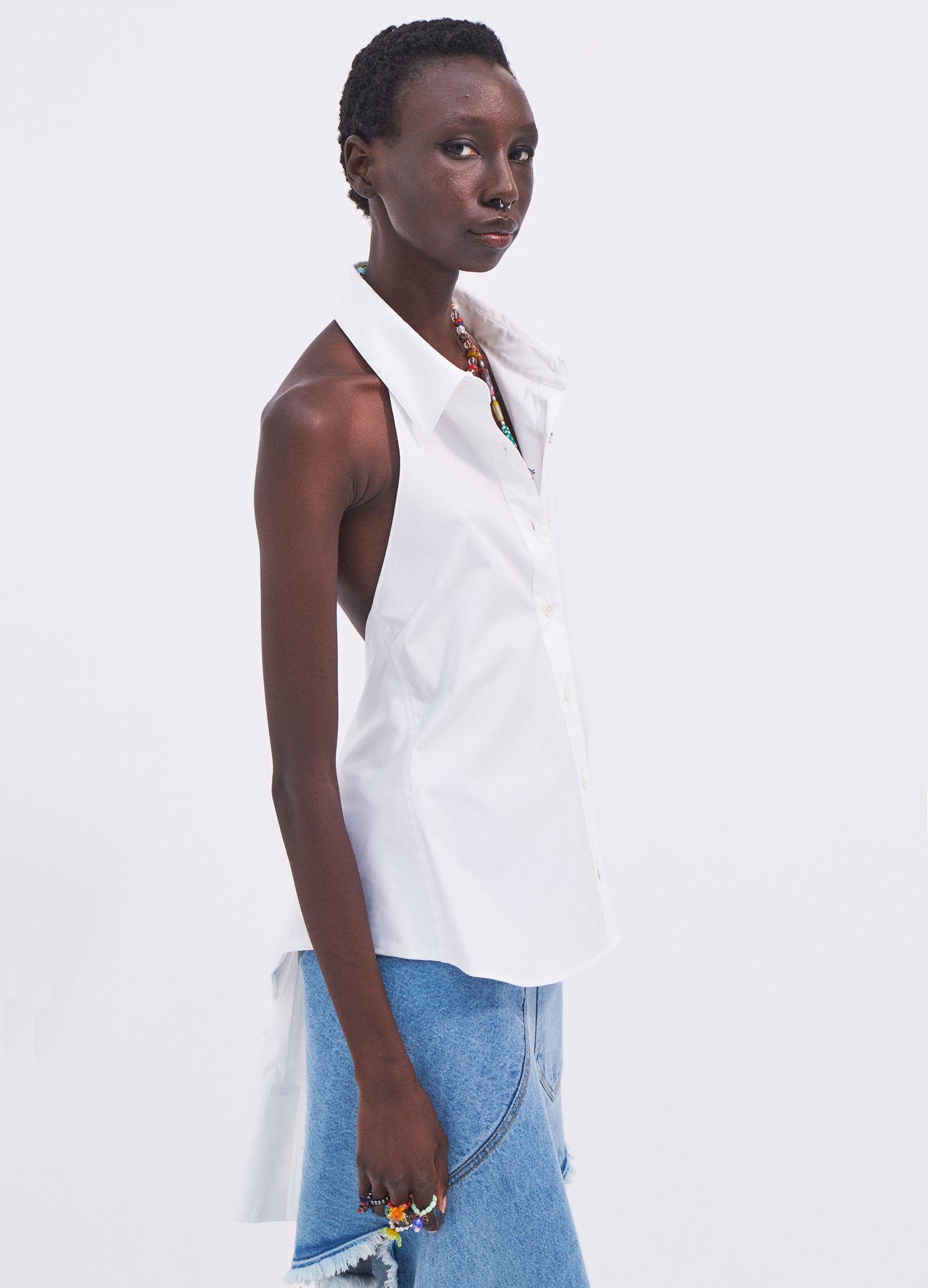 MONSE Sleeveless Halter Back Detail Shirt in White on model side view