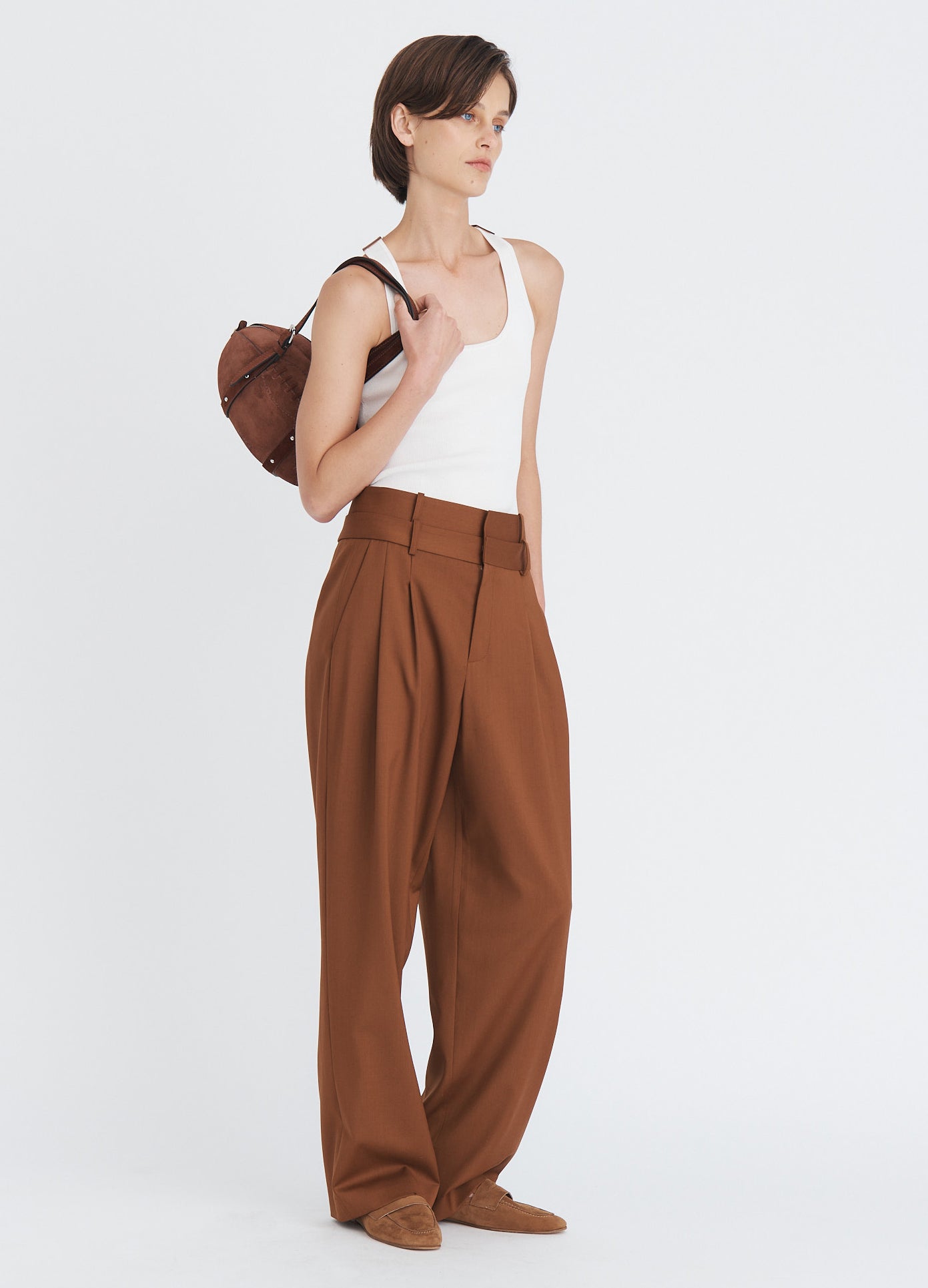 MONSE Suede Football Bag in brown split suede on model's shoulder full front side view