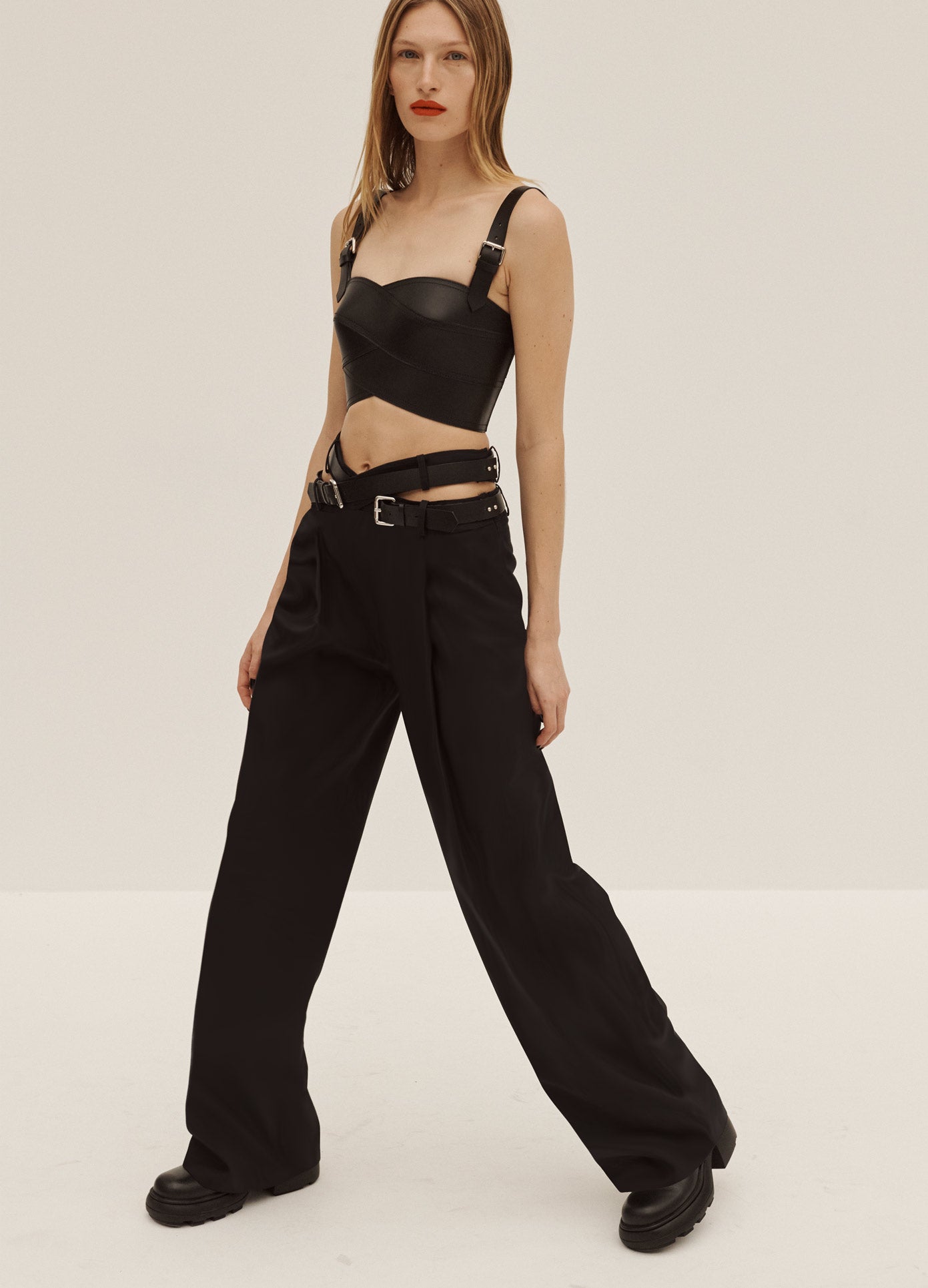 MONSE Crisscross Trousers in Black on Model Walking Side View