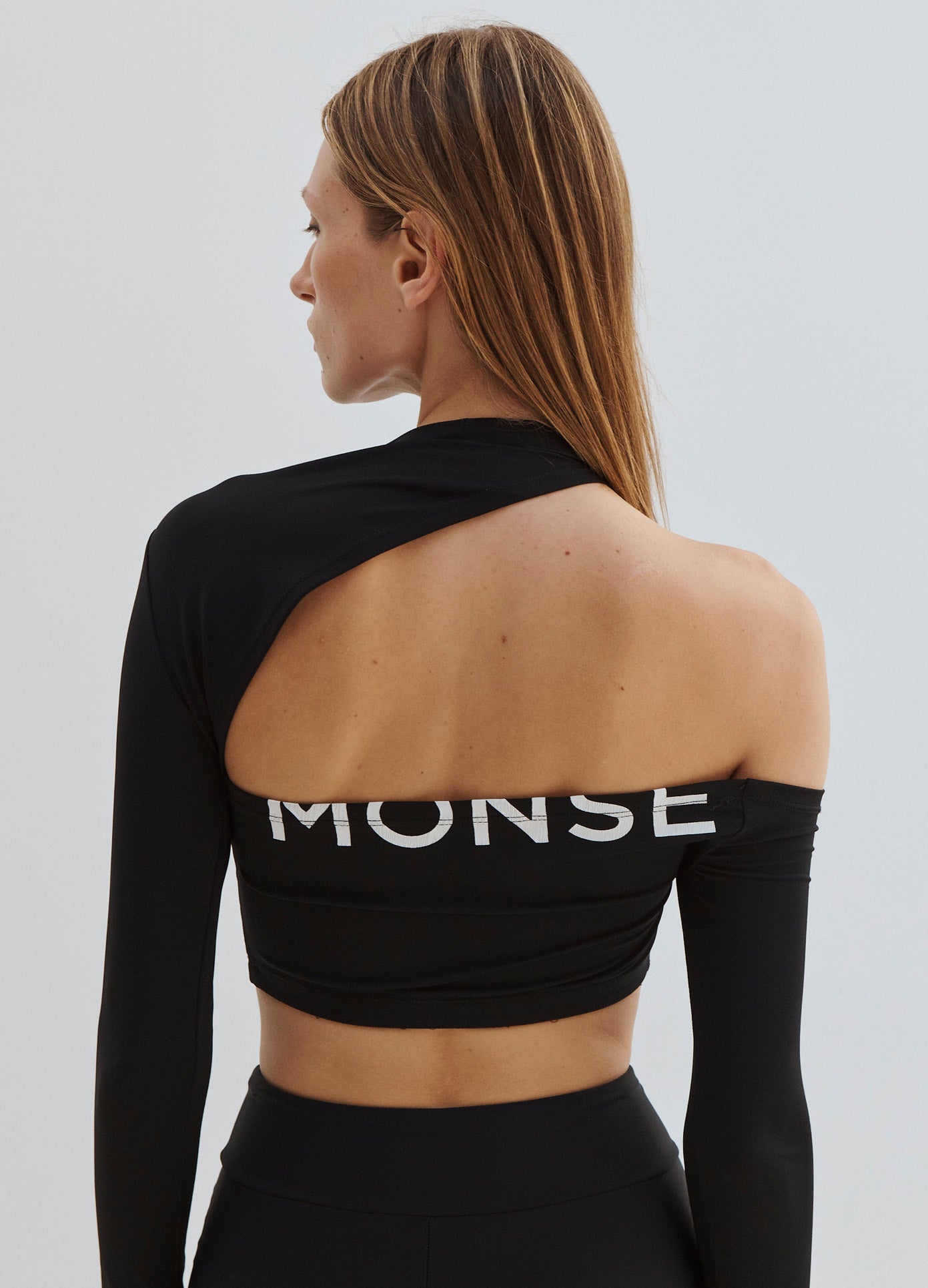 MONSE Long Sleeve Cut Out Crop Top in Black on Model Back View