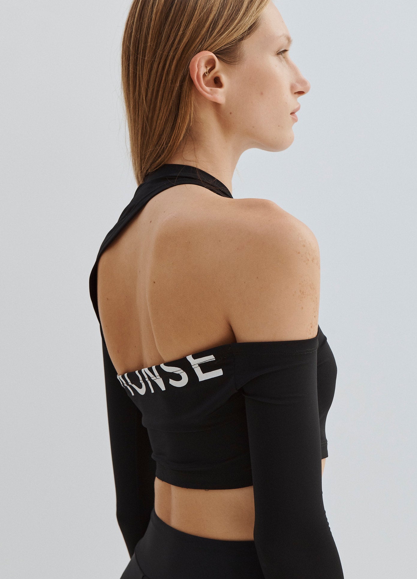MONSE Long Sleeve Cut Out Crop Top in Black on Model Side View