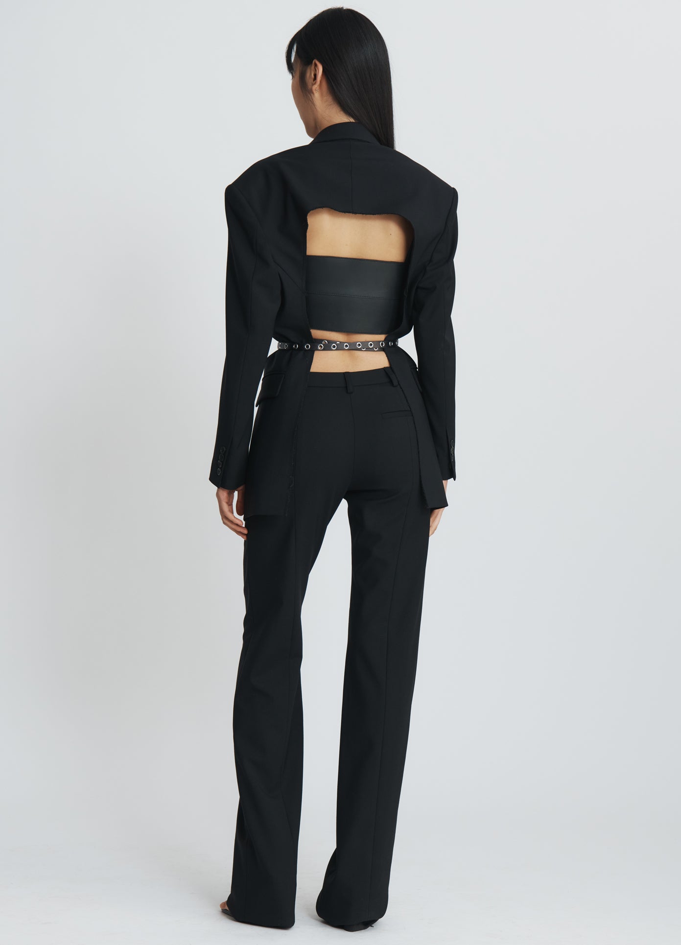 MONSE Asymmetrical Waistband Long Leg Trousers in black on model full back view