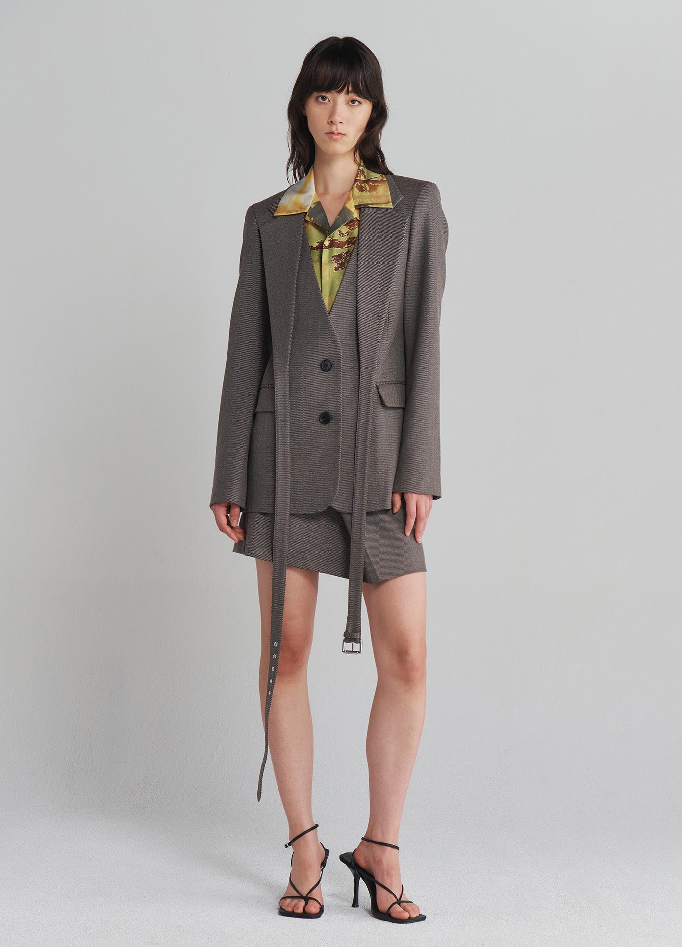 MONSE Criss Cross Front Jacket in Taupe on model with knee bent full front view