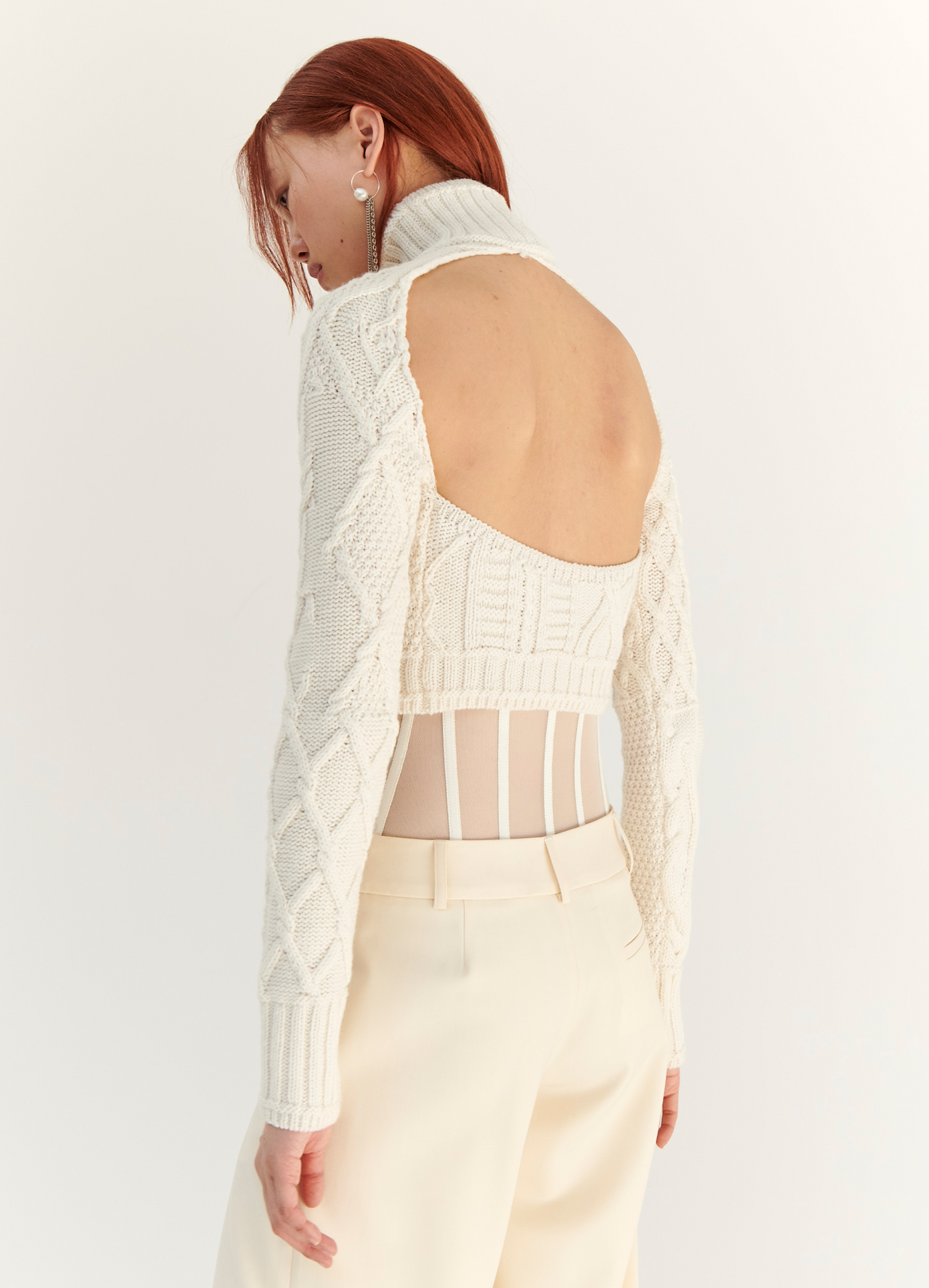 MONSE Cropped Cable Sweater in Ivory on model wearing ivory trousers back detail view