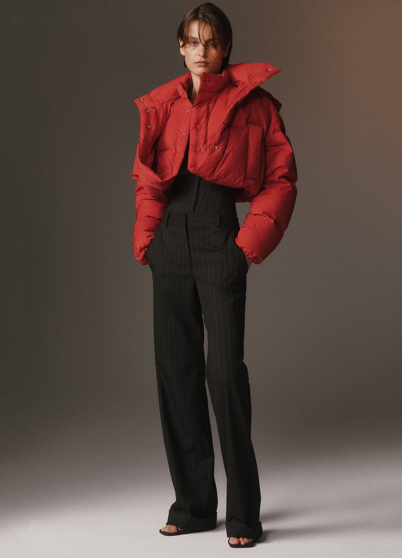 MONSE Cropped Loop Hem Doubled Puffer Jacket in molten lava on model lookbook image
