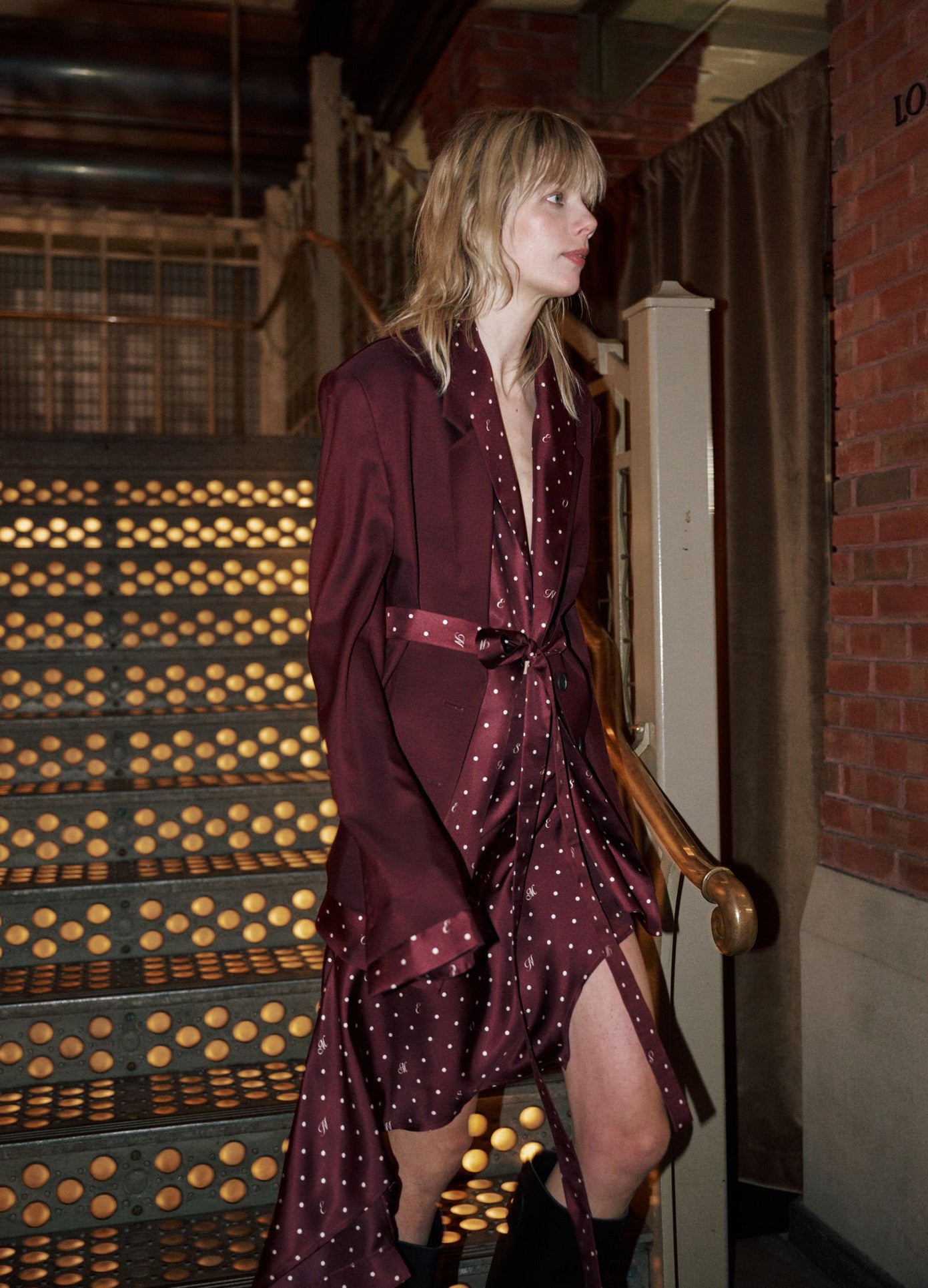 MONSE Deconstructed Pajamas Skirt in burgundy on runway model walking down stairs backstage