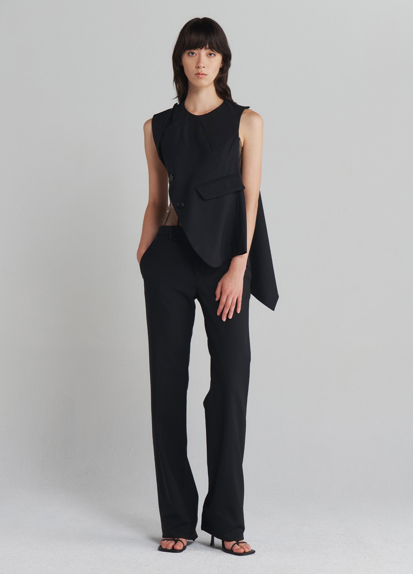 MONSE Deconstructed Tailored Top in Black on model with hand in pocket full front view