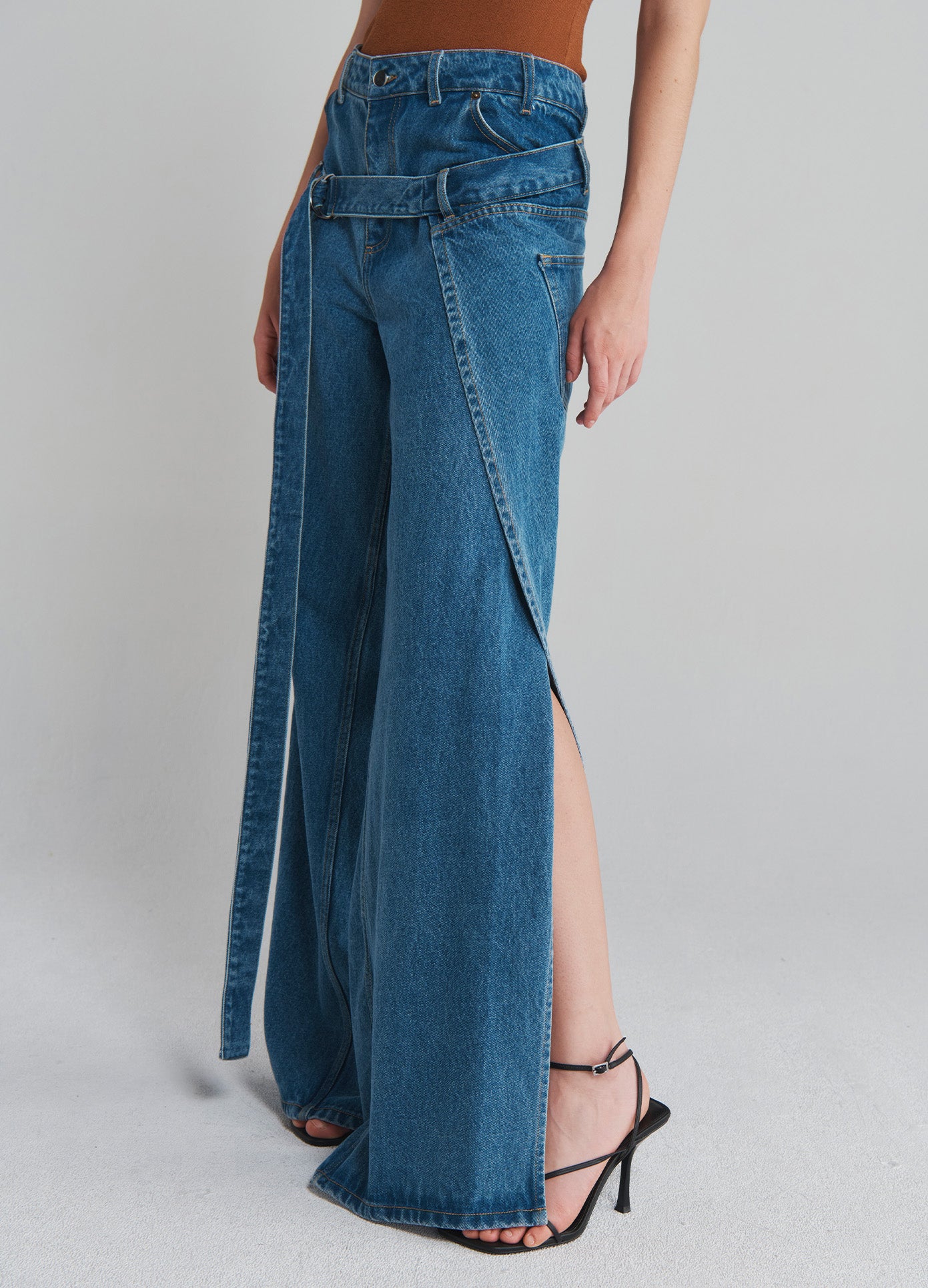 MONSE Deconstructed Wrap Denim Jeans in Indigo on model side bottom view