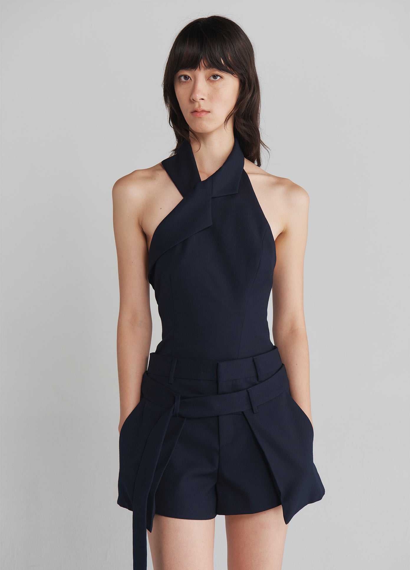 MONSE Deconstructed Wrap Tailored Shorts in Navy on model front top view