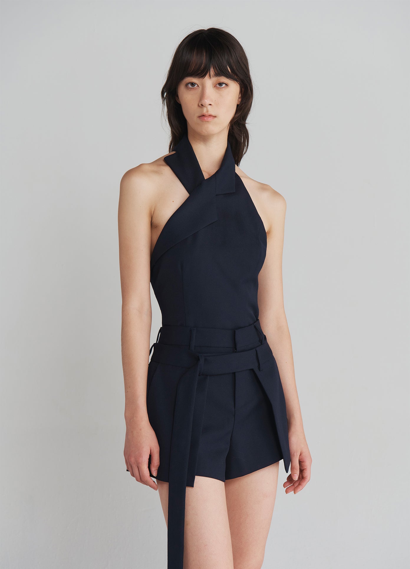 MONSE Deconstructed Wrap Tailored Shorts in Navy on model side view