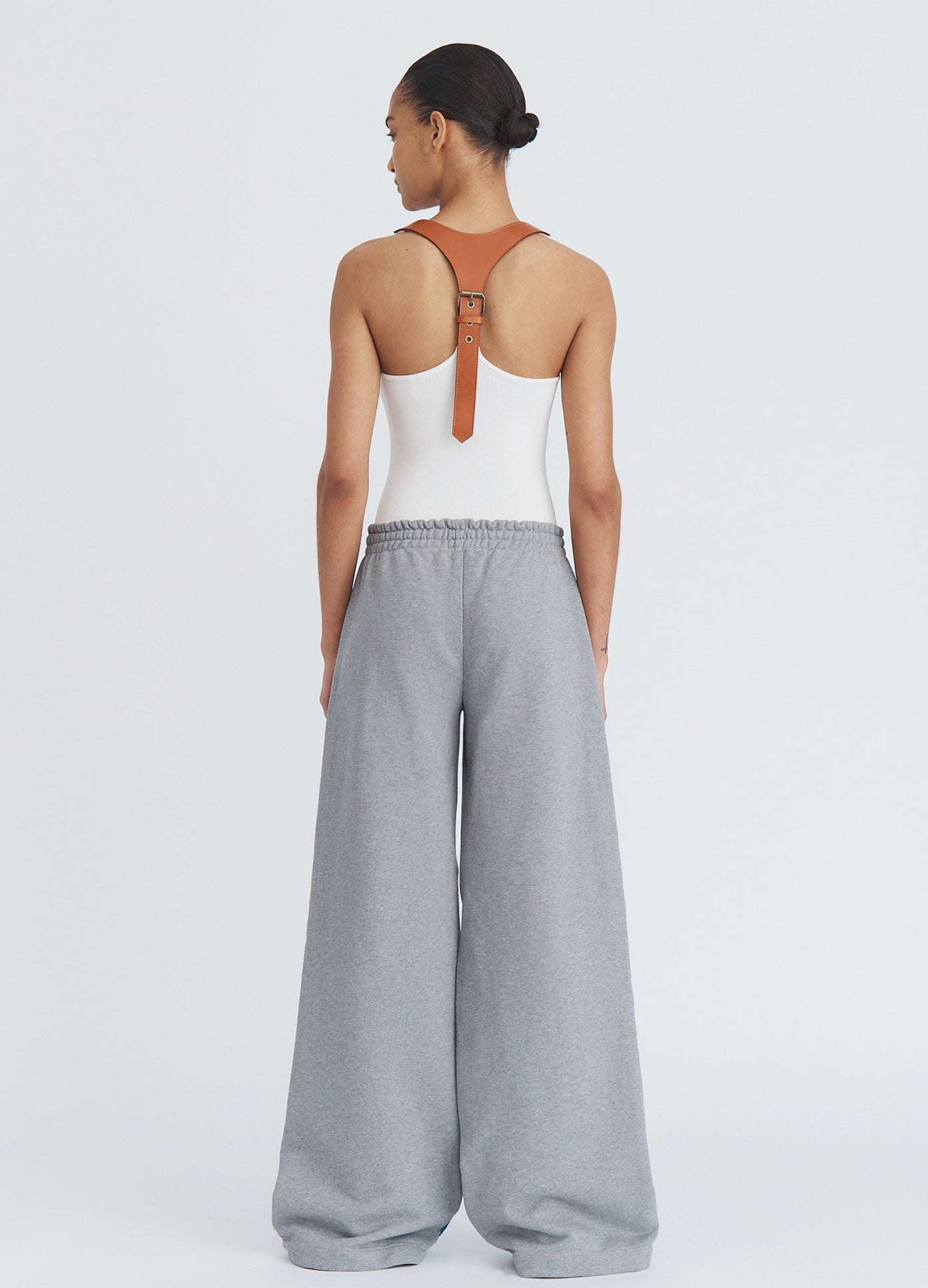 MONSE Denim Combo Sweatpants in indigo on model full back view