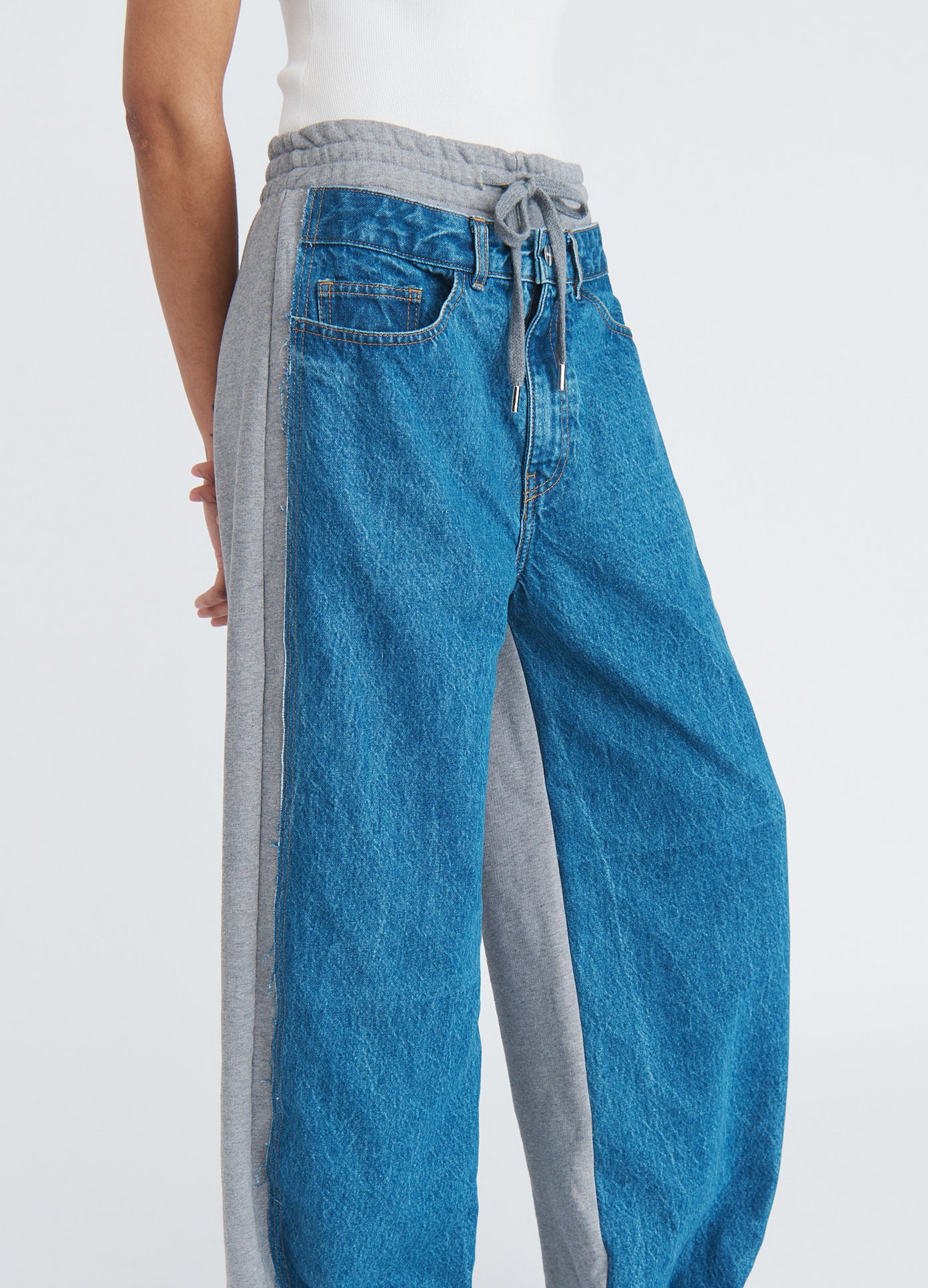 MONSE Denim Combo Sweatpants in indigo on model side detail view