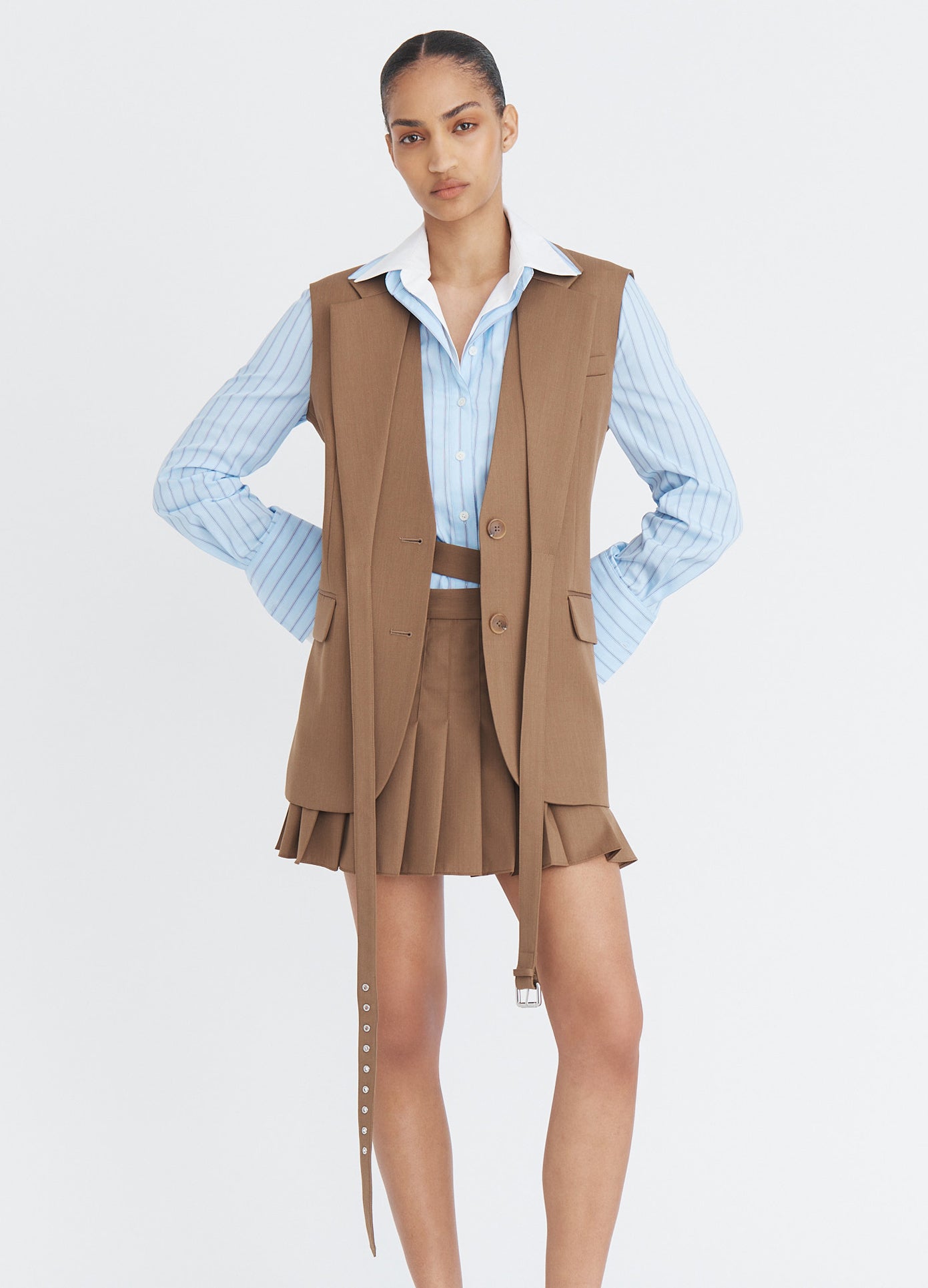 MONSE Double Waistband Pleated Skirt in beige on model wearing suit vest full front view