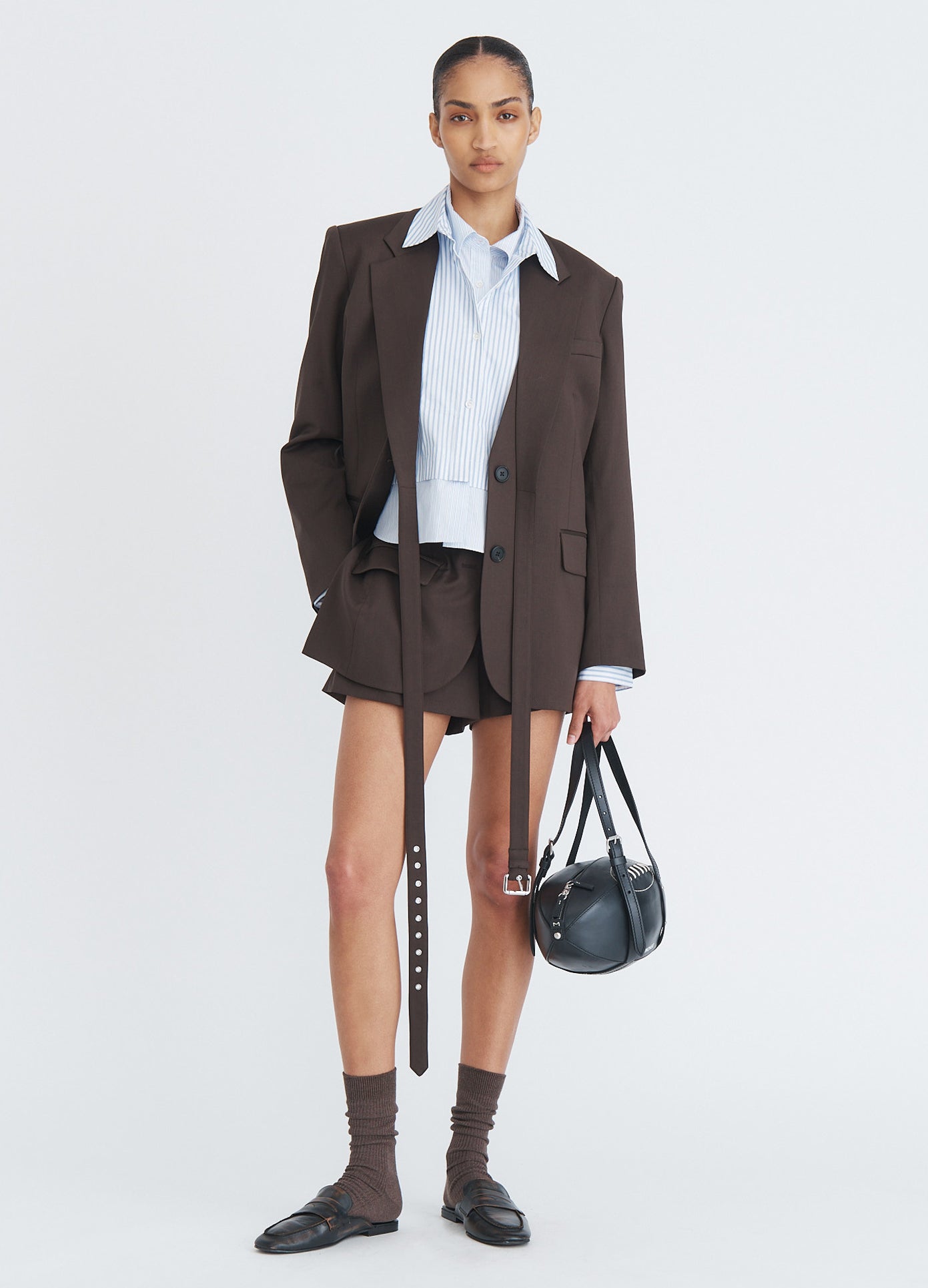 MONSE Doubled Cropped Button Down Shirt in blue multi stripe on model wearing suit jacket