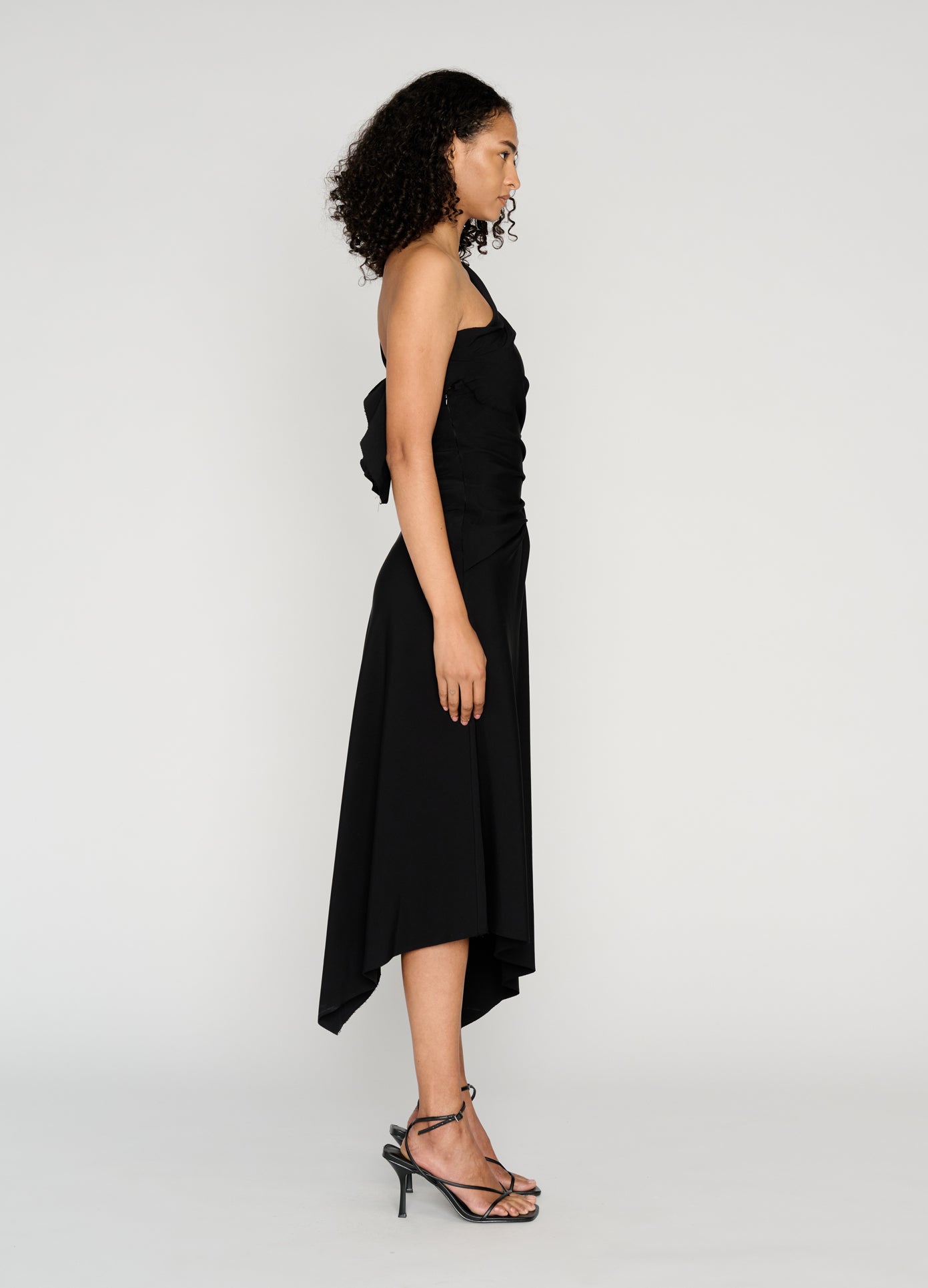 MONSE Draped Towel Dress in black on model full side view