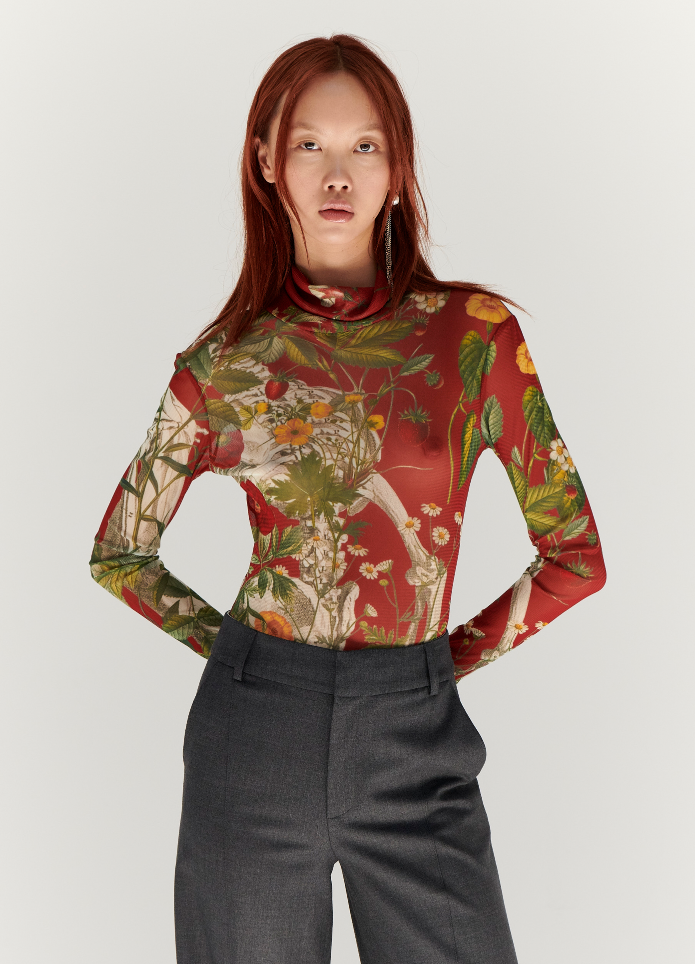 MONSE Floral Skeleton Print Mesh Turtleneck in Red Multi on model with hands behind back front view