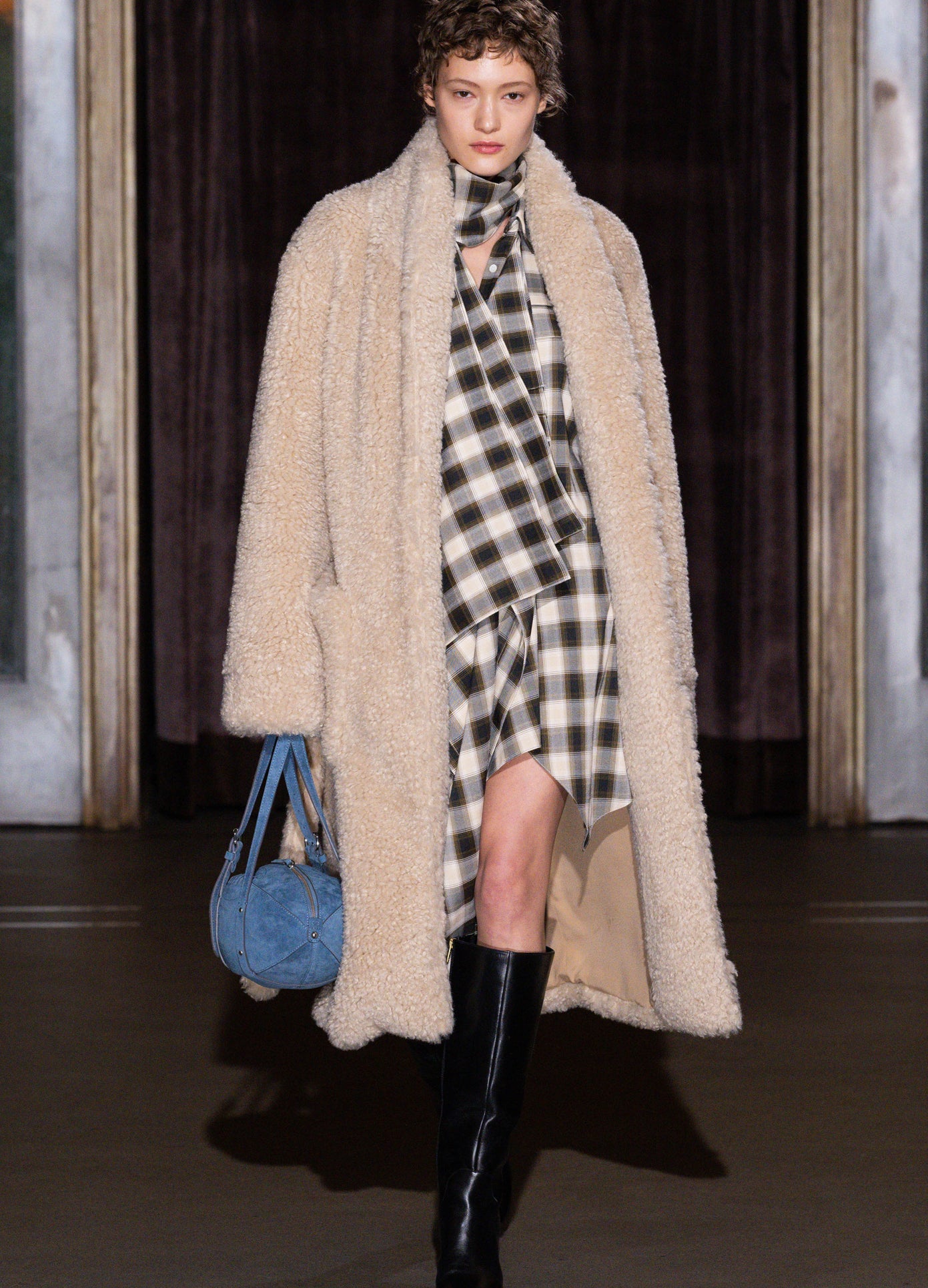 MONSE Football Bag Purse in blue carried by runway model