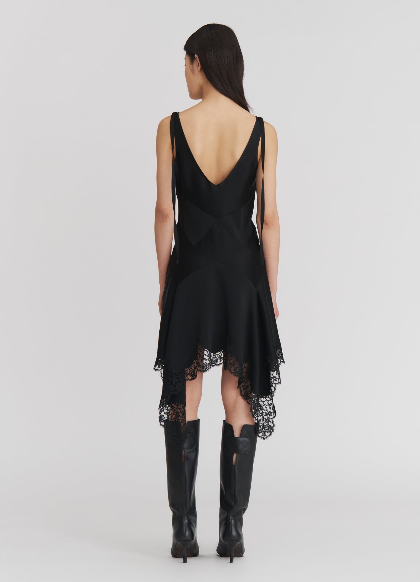 MONSE Lace Triangle Flared Mini Dress in Black on model full back view