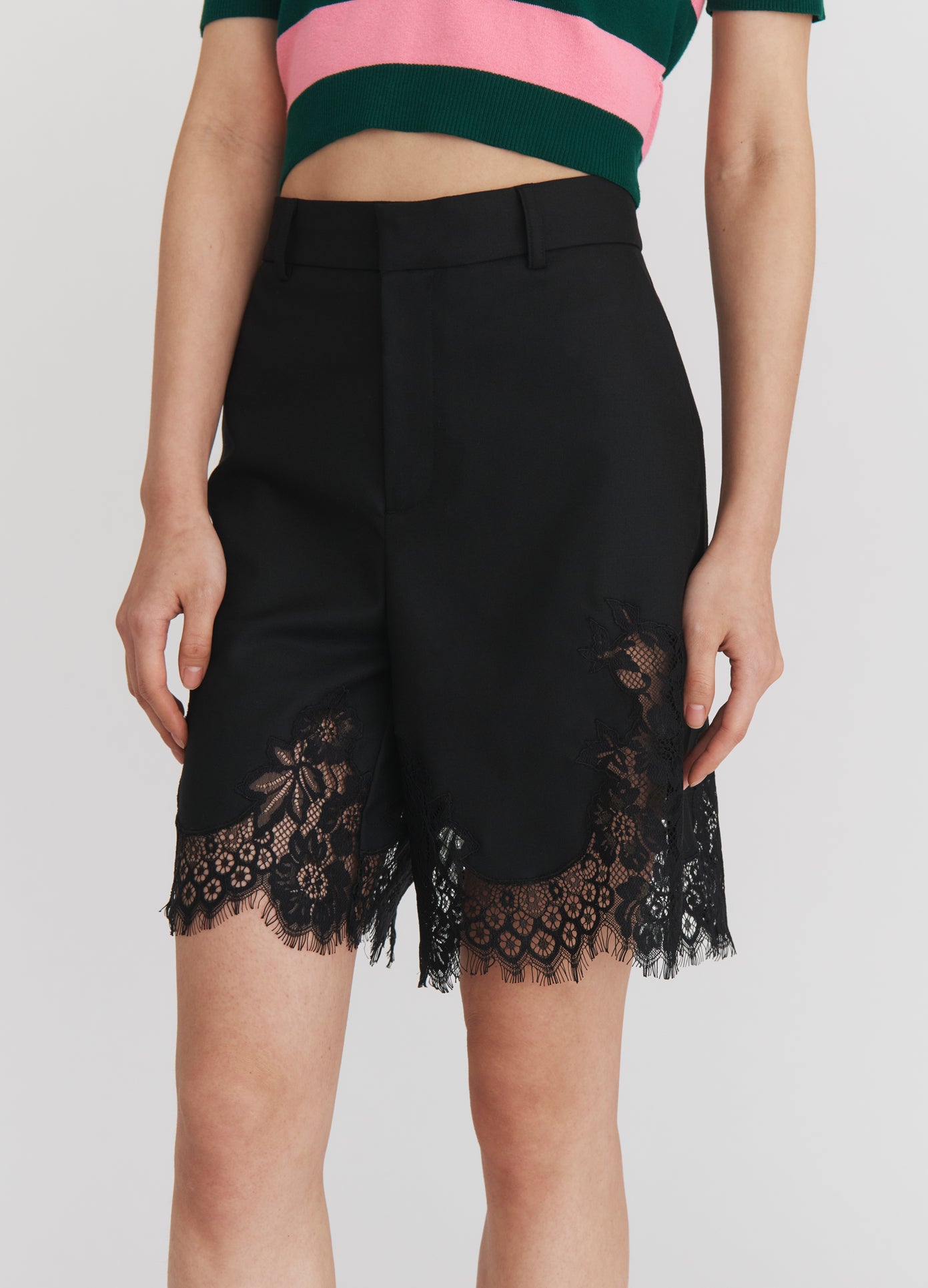 MONSE Lace Trimmed Tailored Shorts in Black on model front detail view