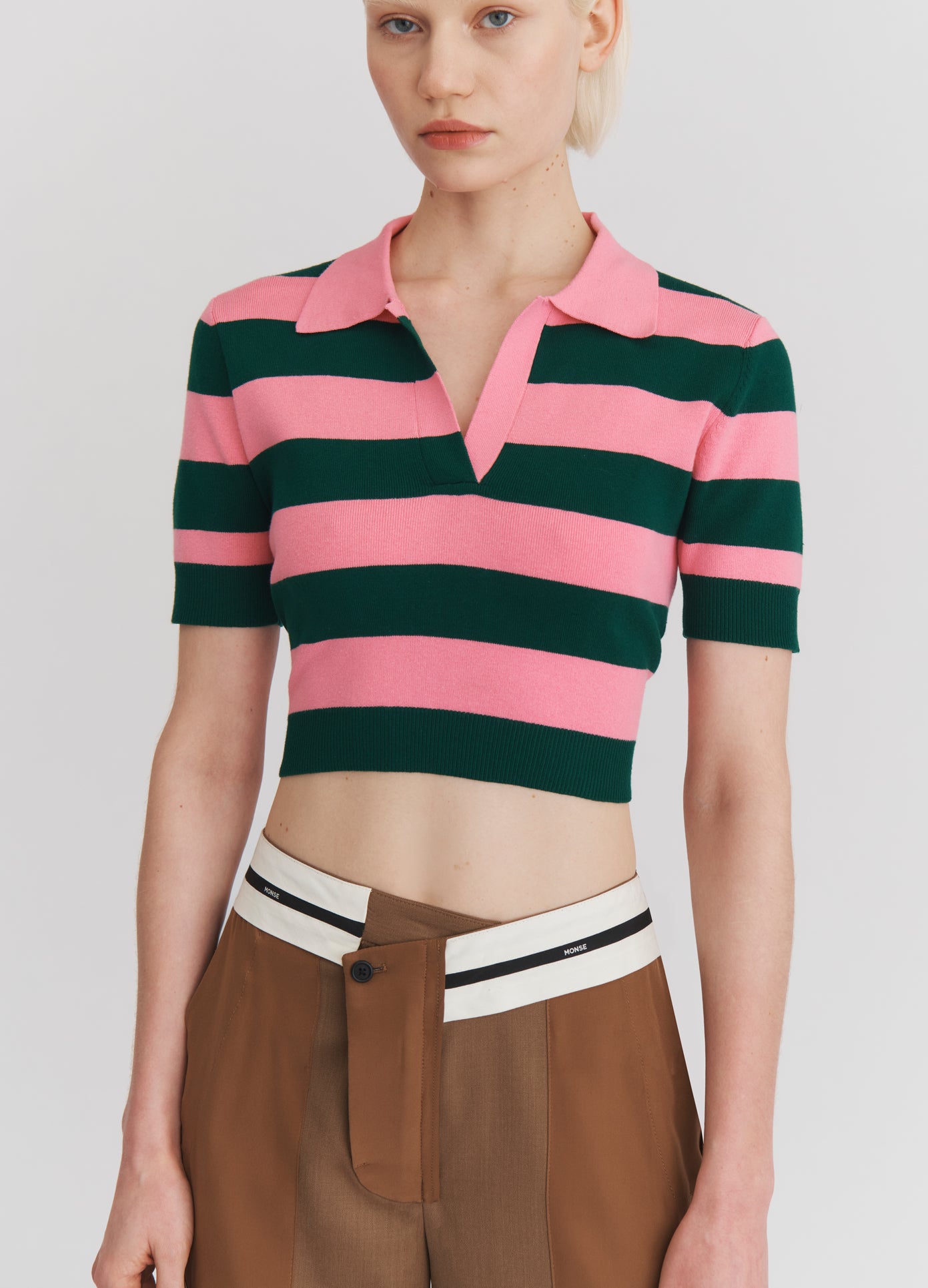 MONSE Leather Belt Back Cut Out Short Sleeve Knitted Top in Green and Pink on model front view