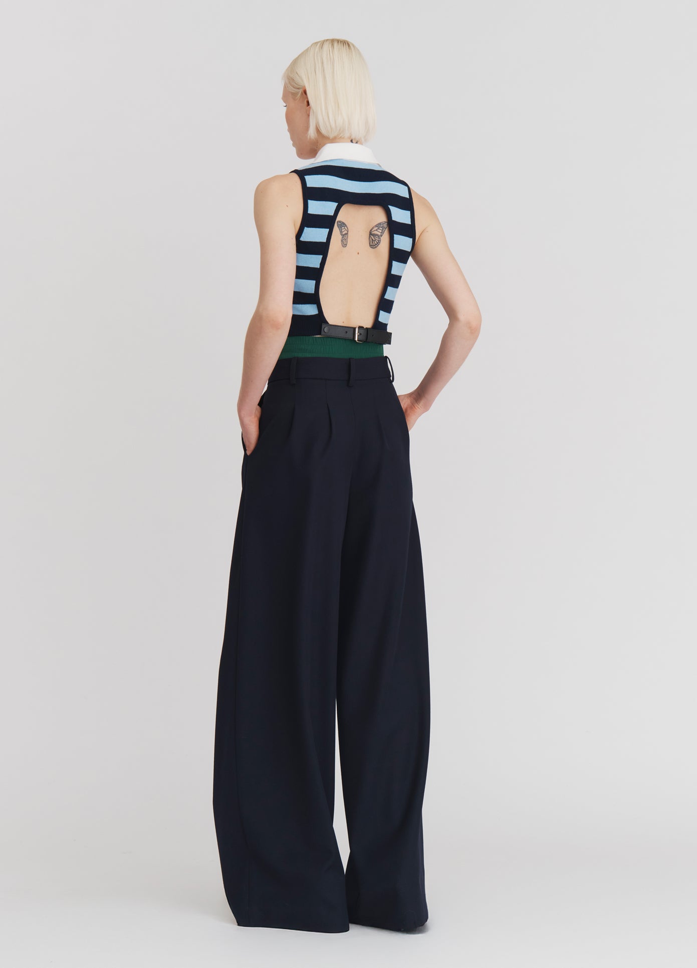 MONSE Leather Belt Back Cut Out Sleeveless Knitted Top in Navy Stripe on model full back view