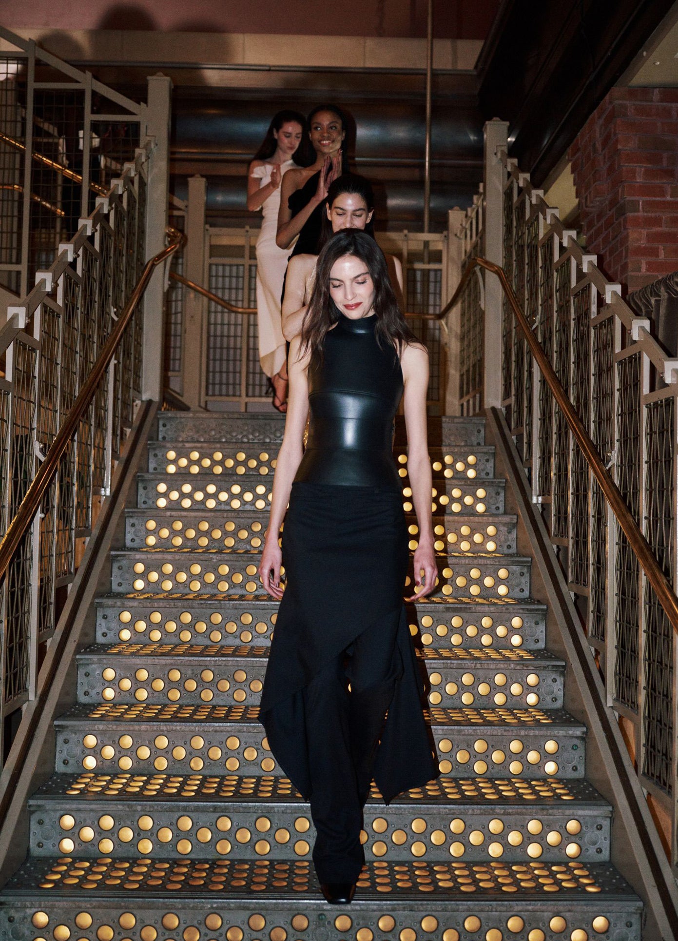 MONSE Leather Halter Top in black on model walking down stairs at the show