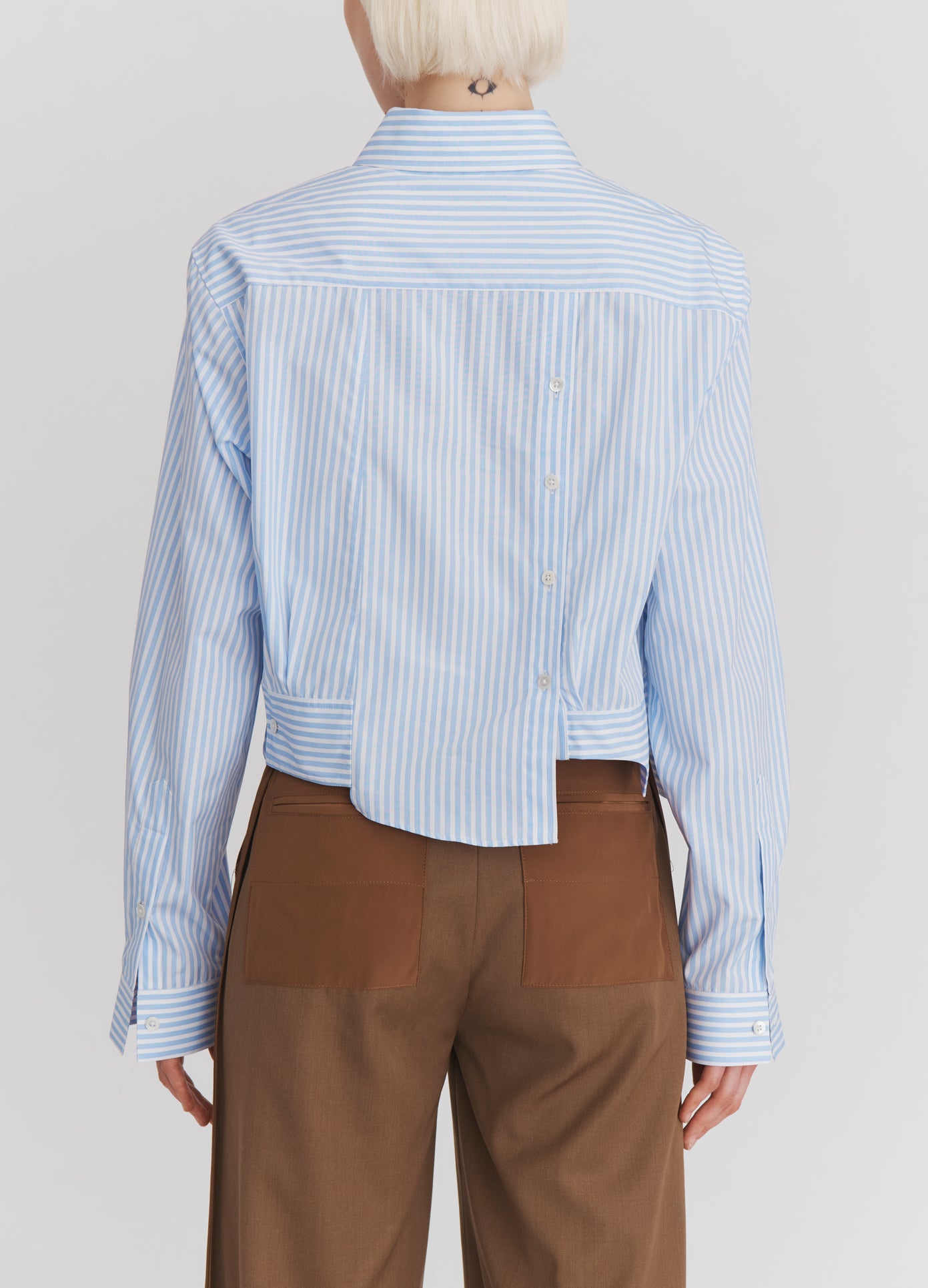 MONSE Paneled Cropped Shirt in Light Blue Stripe on model back view