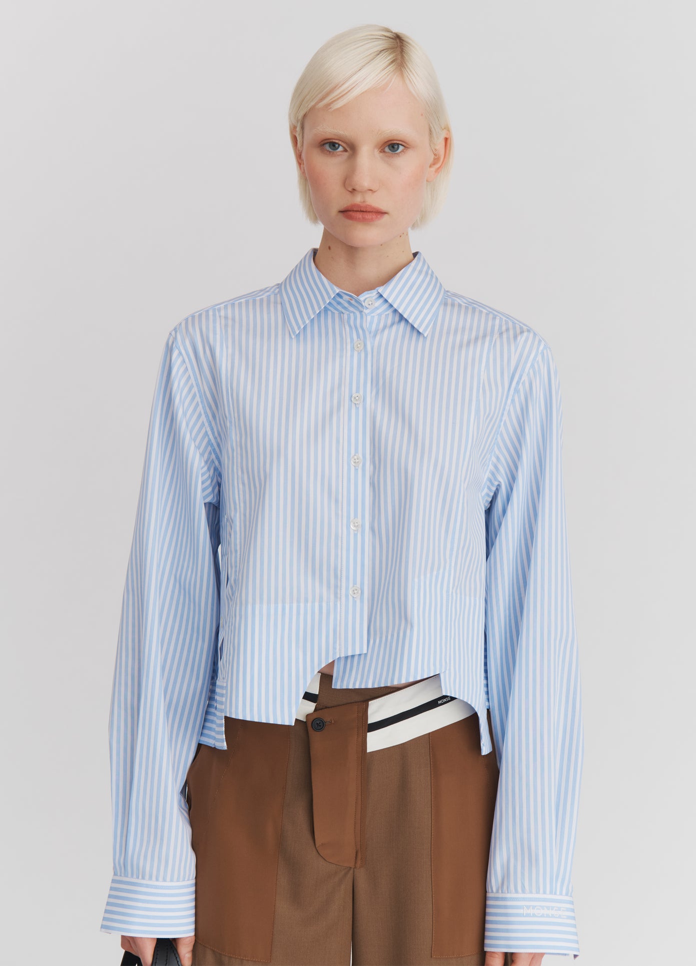 MONSE Paneled Cropped Shirt in Light Blue Stripe on model front view