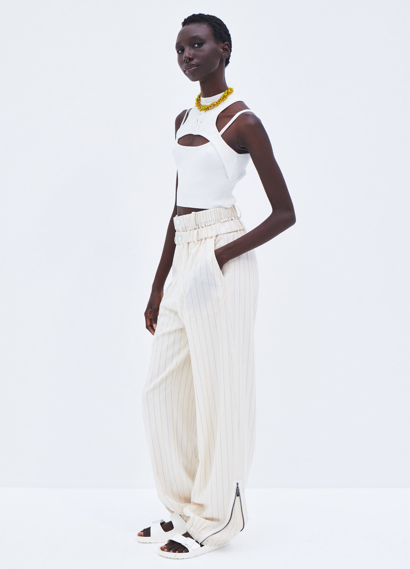 MONSE Pinstripe Double Waistband Zip Detail Pant in Ivory Pinstripe on model full side view