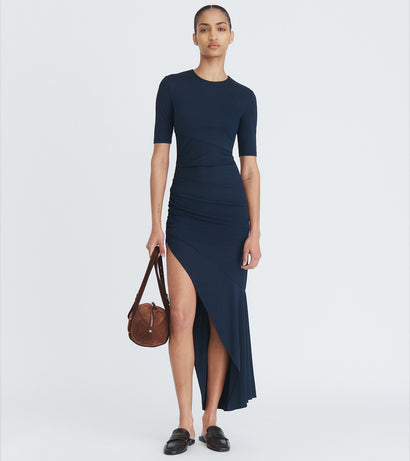 MONSE Pre-Fall 2025 Navigation image of a woman wearing a navy dress