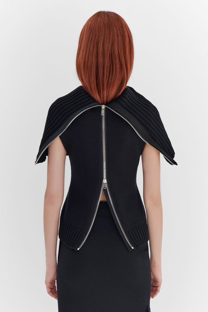 MONSE Resort 2024 Collection Vogue image of model wearing a sweater dress with zipper in the back