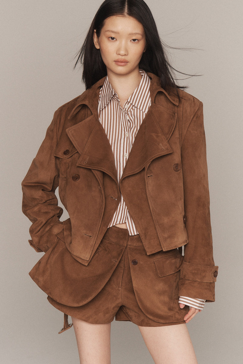 MONSE Resort 2026 collection lookbook image of a model wearing a brown suede jacket and shorts set against a neutral background