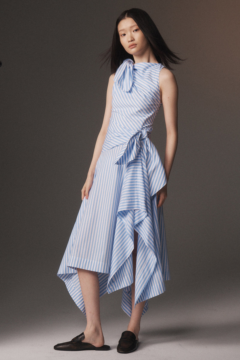 MONSE Resort 2026 collection lookbook image of a model wearing a blue and white striped dress against a gray background