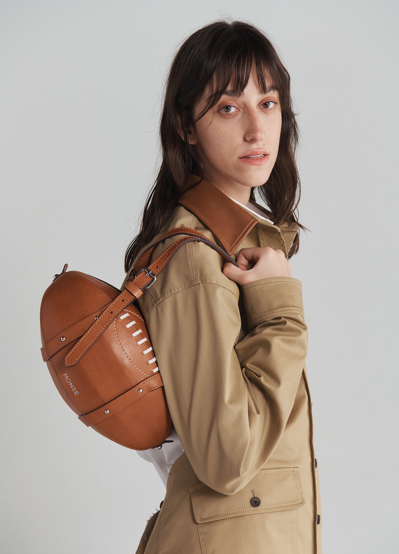 MONSE Rugby Bag in Brown Leather held by model side view