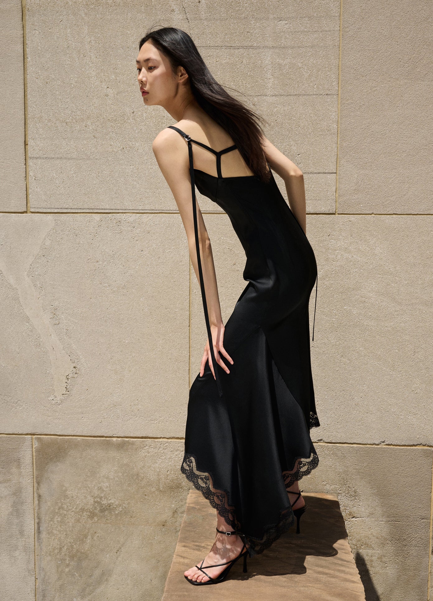 MONSE Slip Dress With Lace Hem in Black on model editorial image