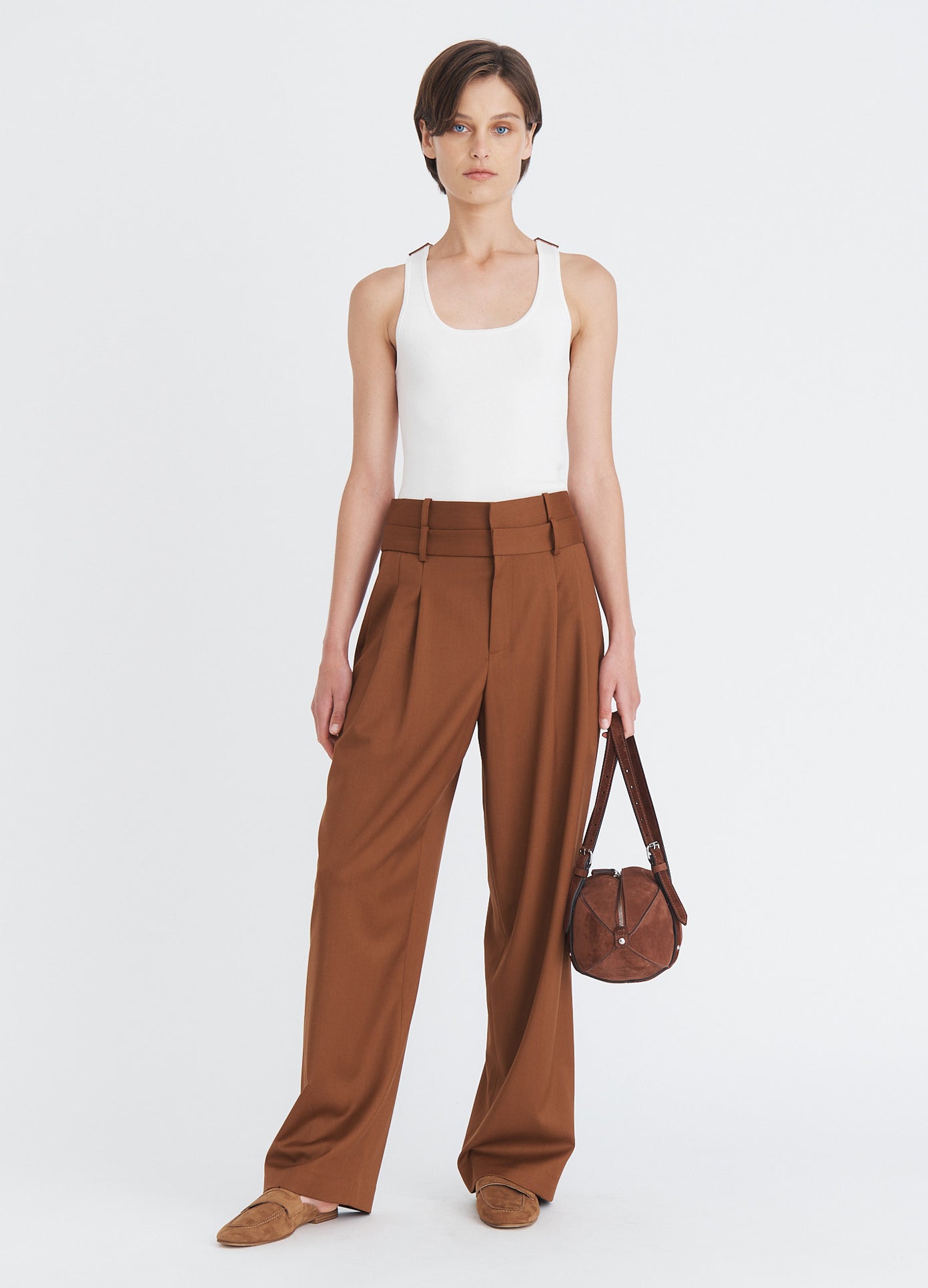 MONSE Suede Football Bag in brown split suede in model's hand full front view