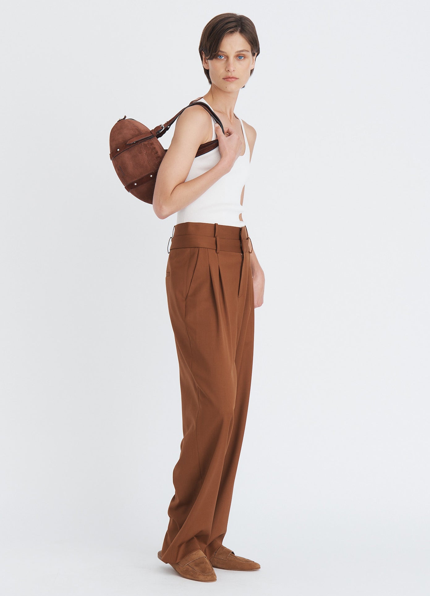 MONSE Suede Football Bag in brown split suede on model's shoulder full side view