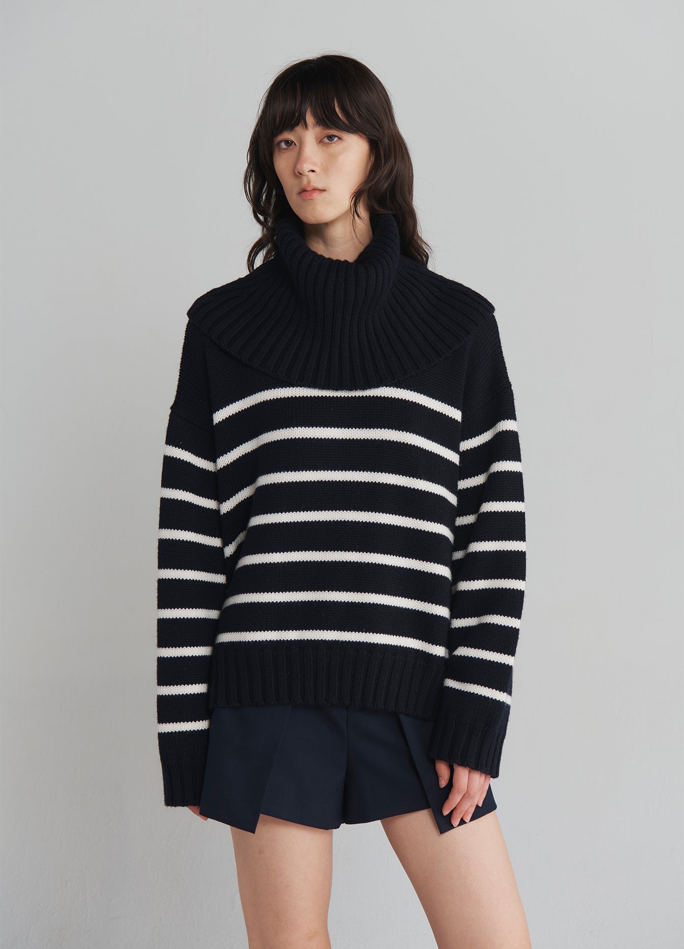 MONSE Turtleneck Striped Sweater in Navy with white stripes on model front view