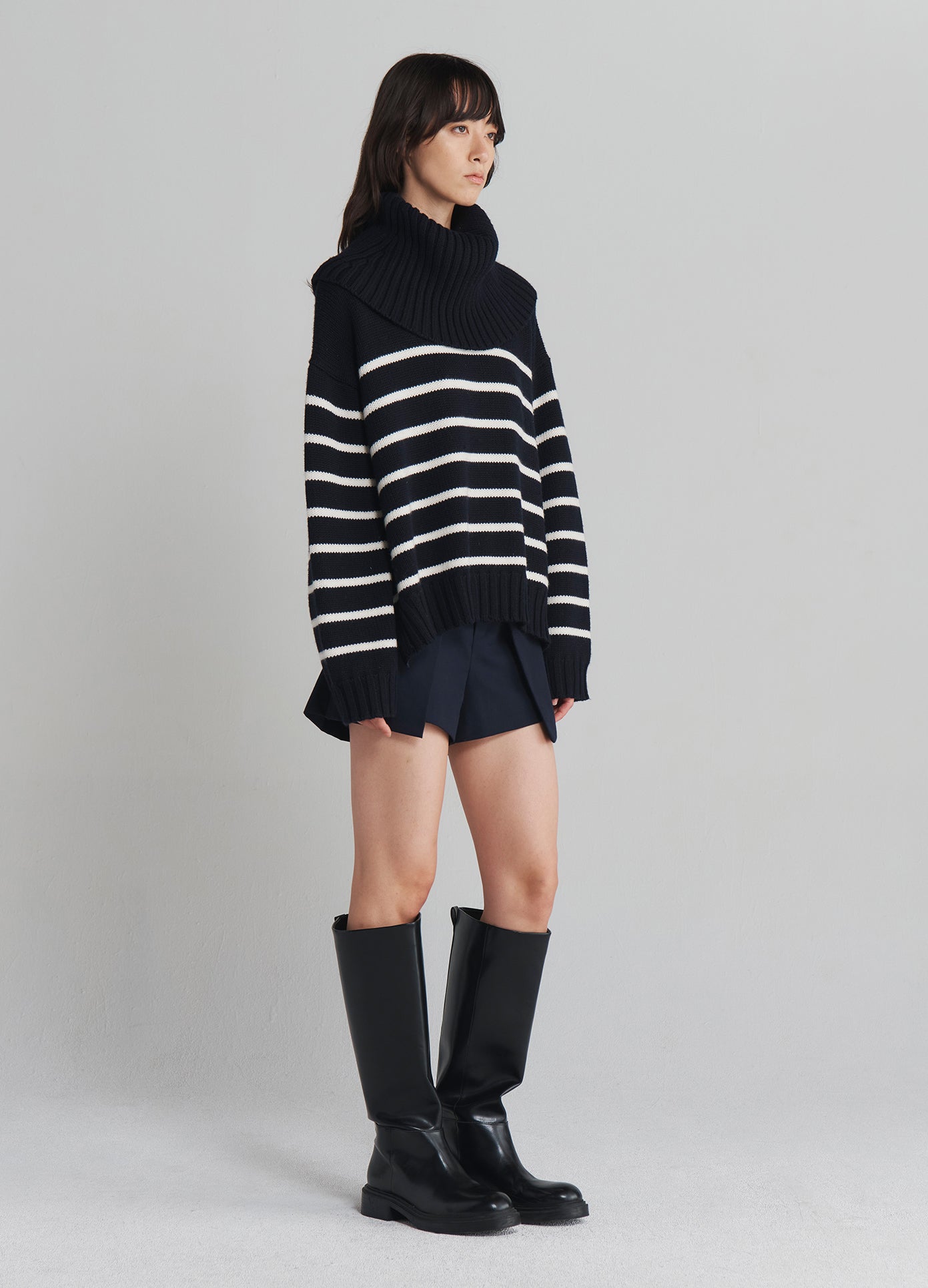 MONSE Turtleneck Striped Sweater in Navy with white stripes on model full side view