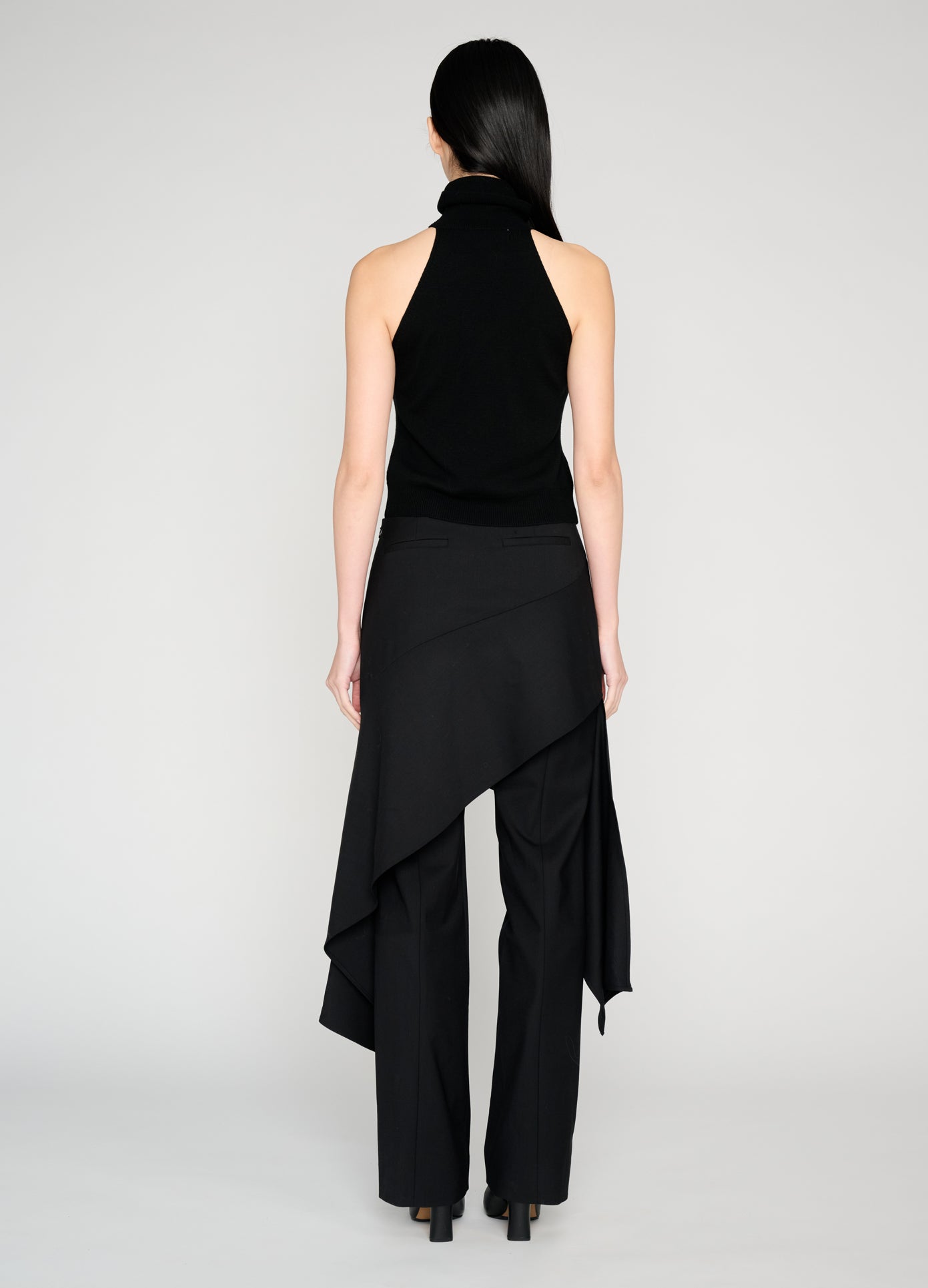 MONSE Twist Front Roll Neck Knit Top in black on model full back view