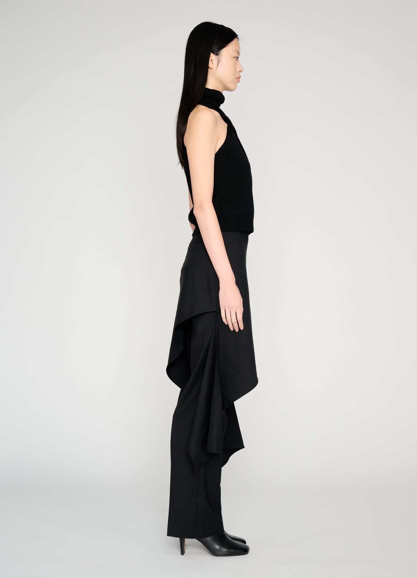 MONSE Twist Front Roll Neck Knit Top in black on model full side view